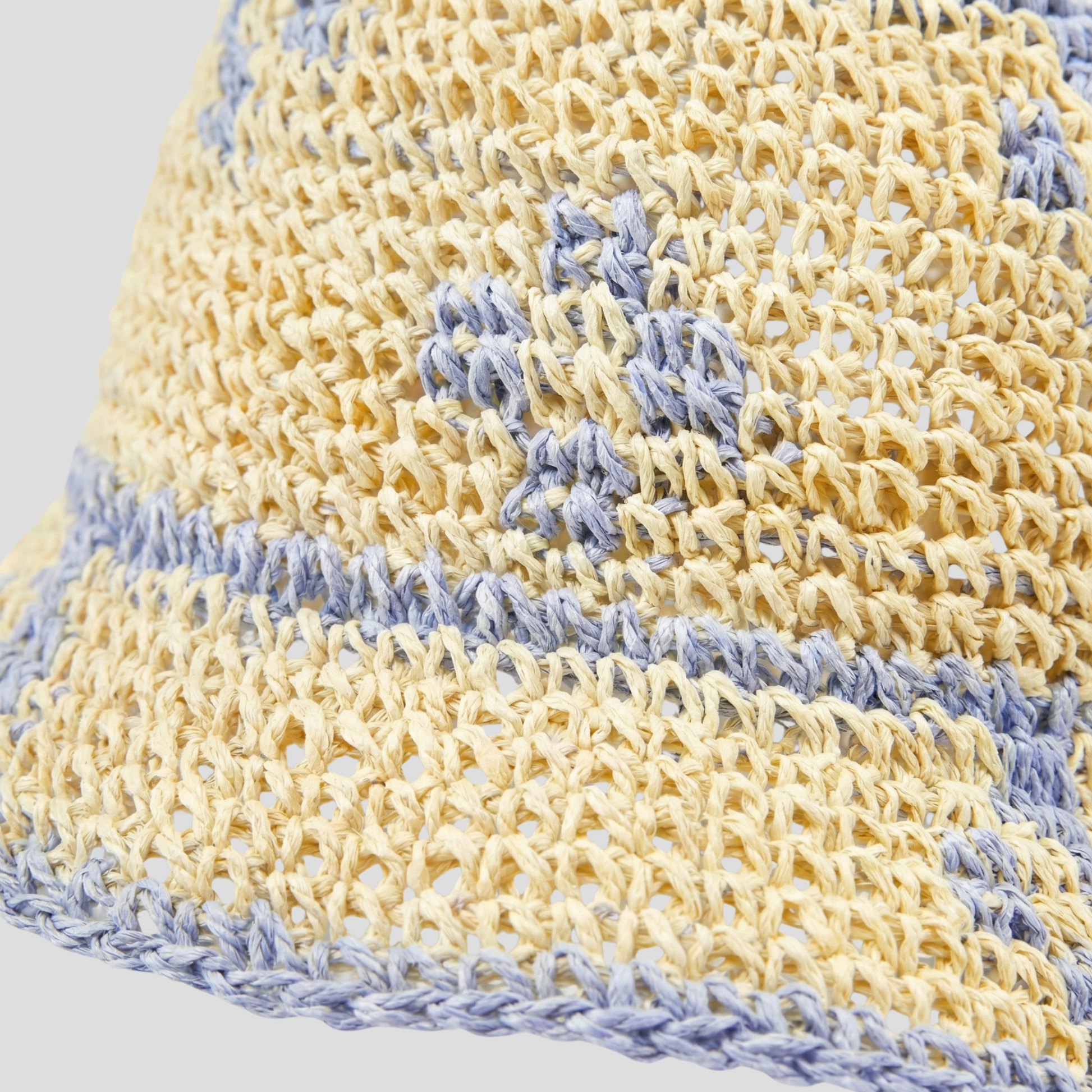 Beige two-tone woven bucket hat with a structured brim for women