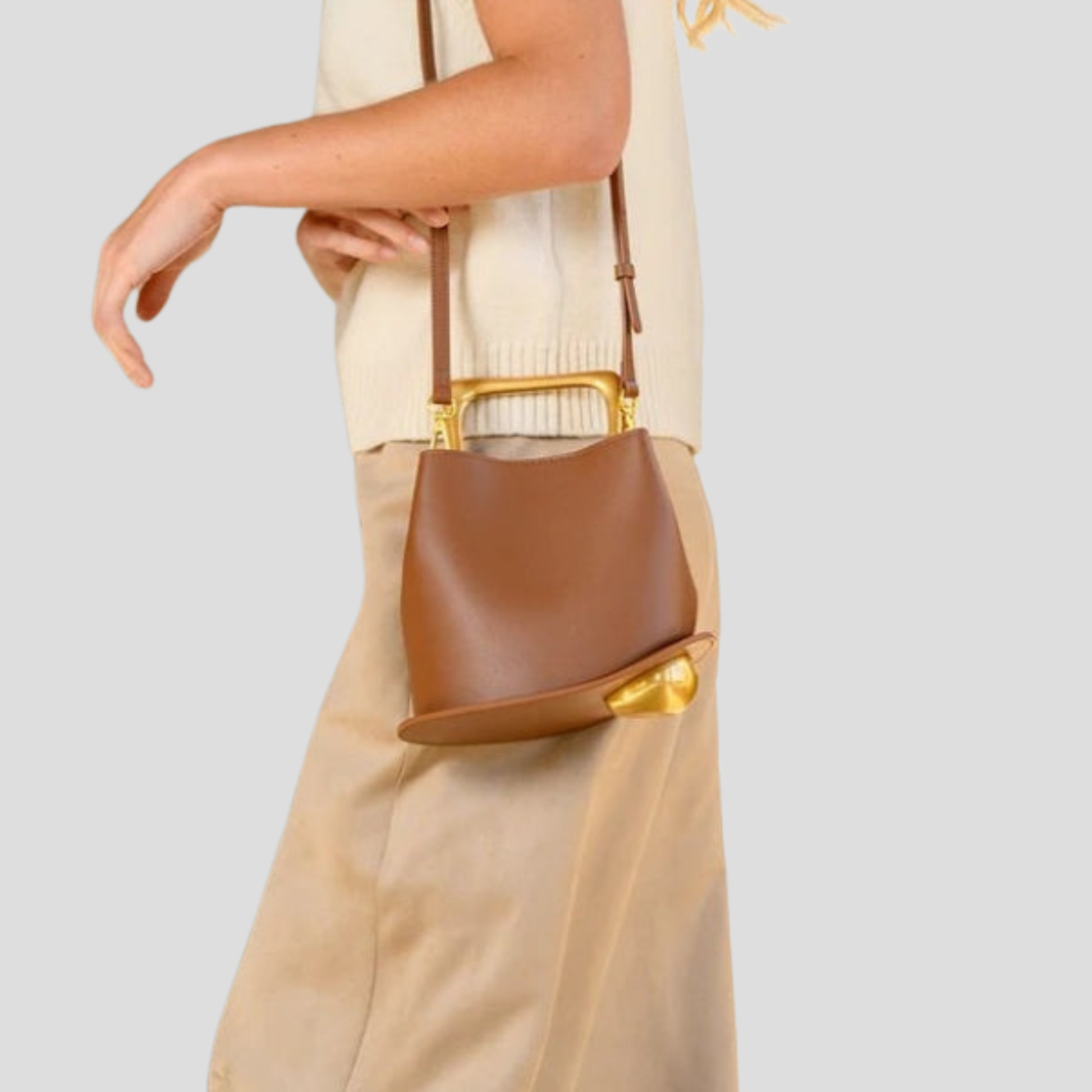Rounded mini handbag with sculpted handle shown in neutral colorways