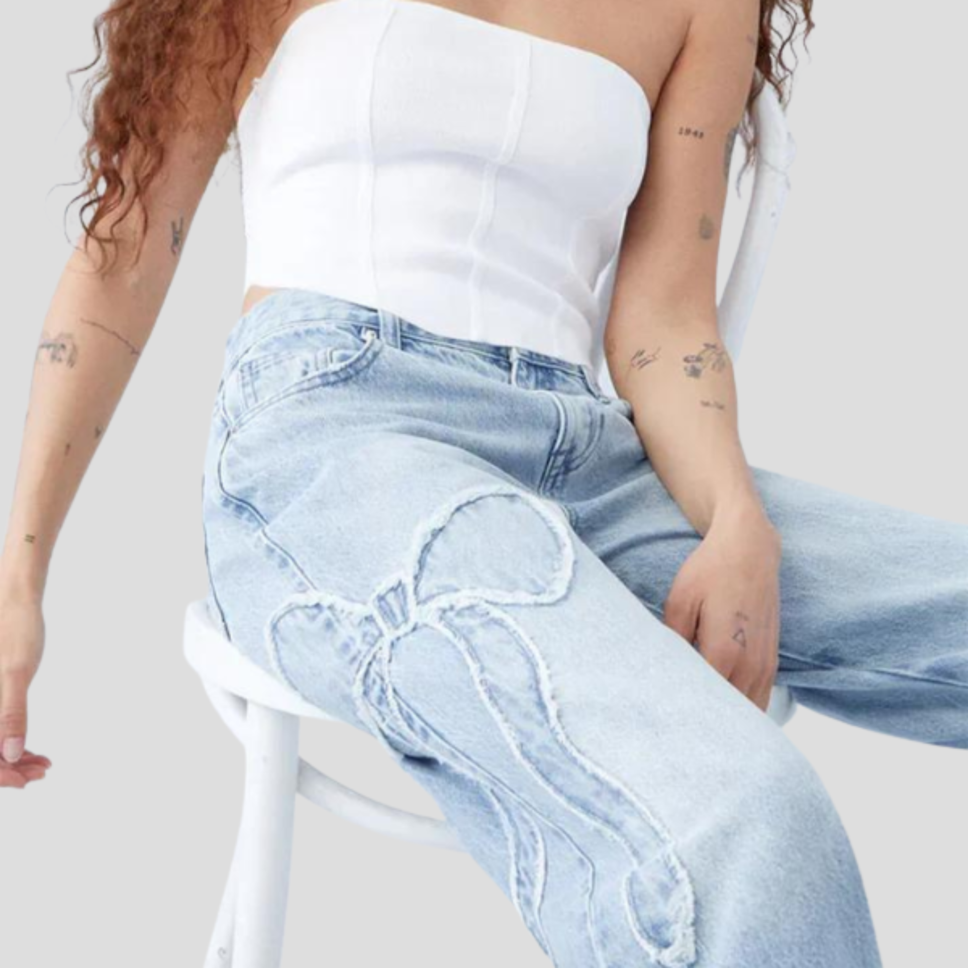 Women's relaxed-fit blue jeans with feminine side bow detail