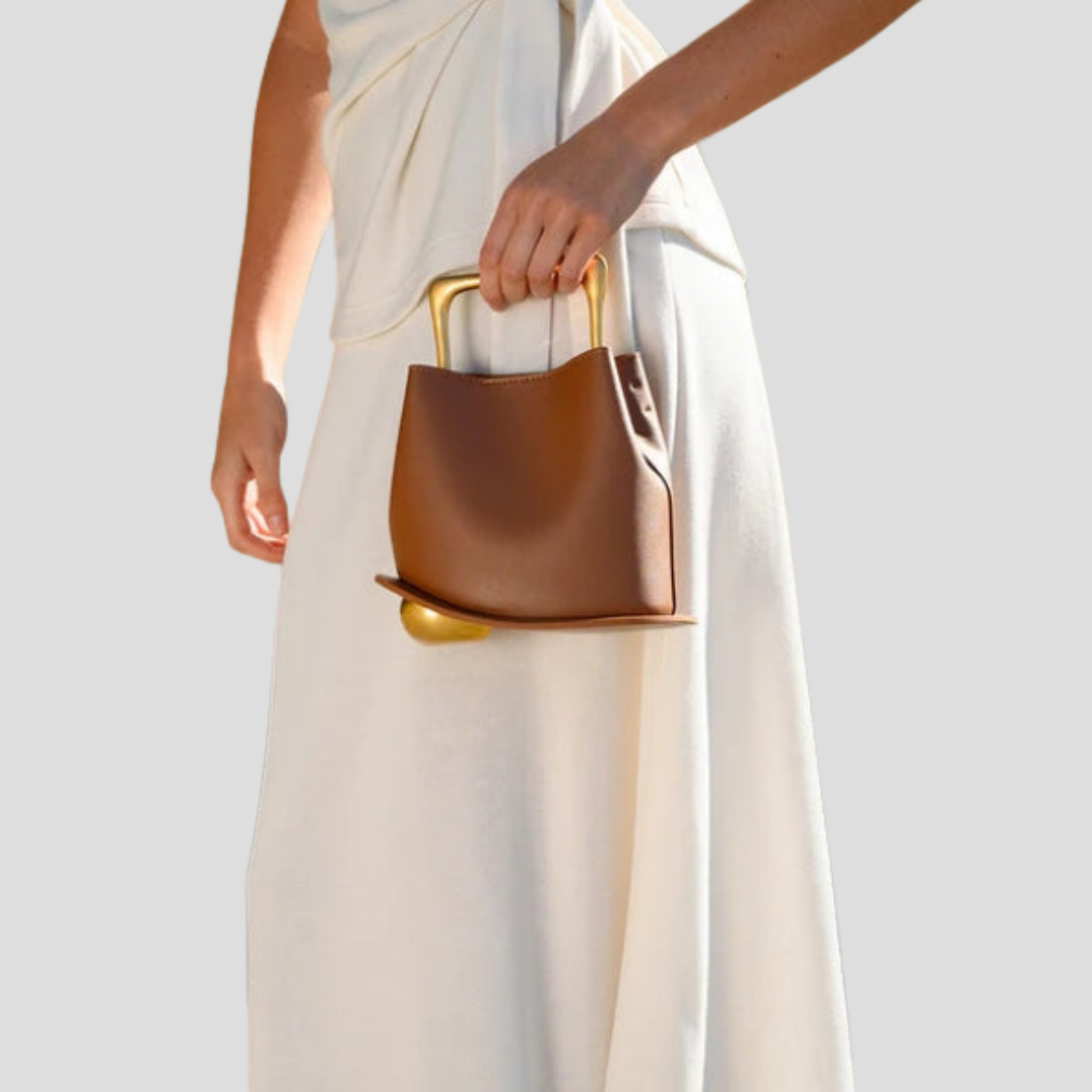 Rounded mini handbag with sculpted handle shown in neutral colorways