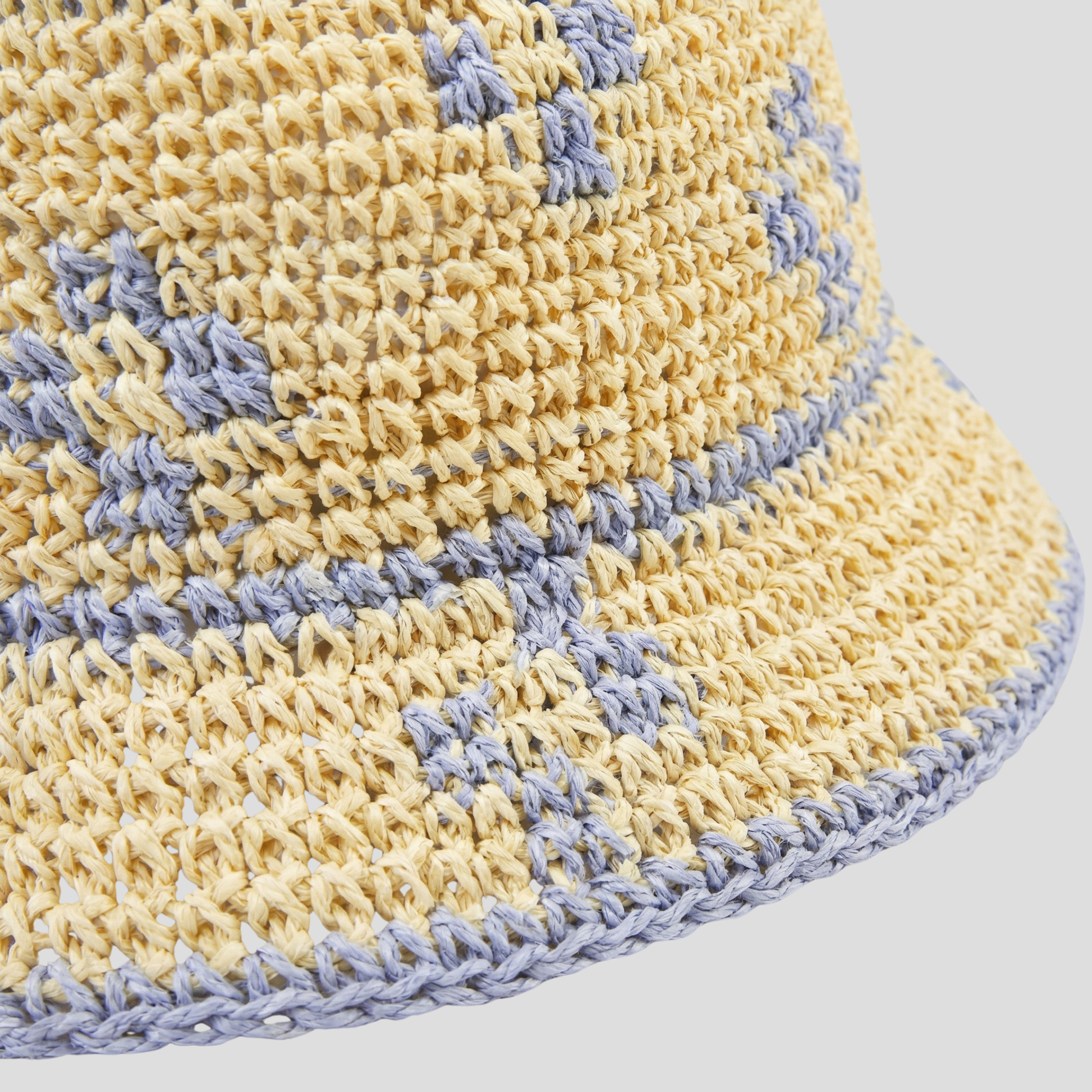Beige two-tone woven bucket hat with a structured brim for women
