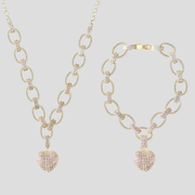 Women's jewelry set with oval chain and pavé heart pendant in gold and silver
