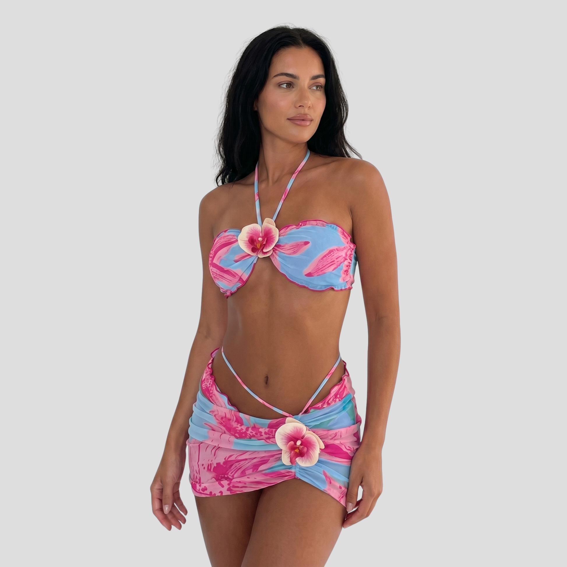 Women's three-piece floral resort set with halter top and wrap-style mini skirt