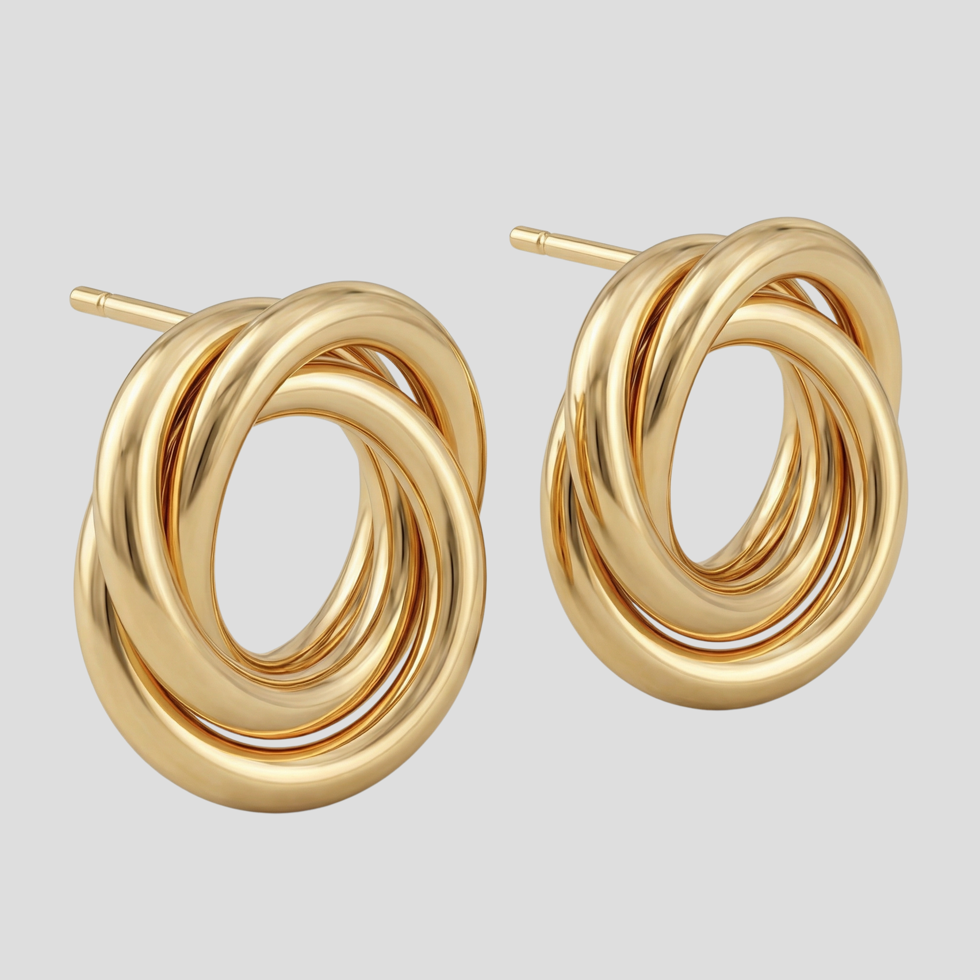 Gold-tone interwoven knot stud earrings with a polished outline for everyday wear