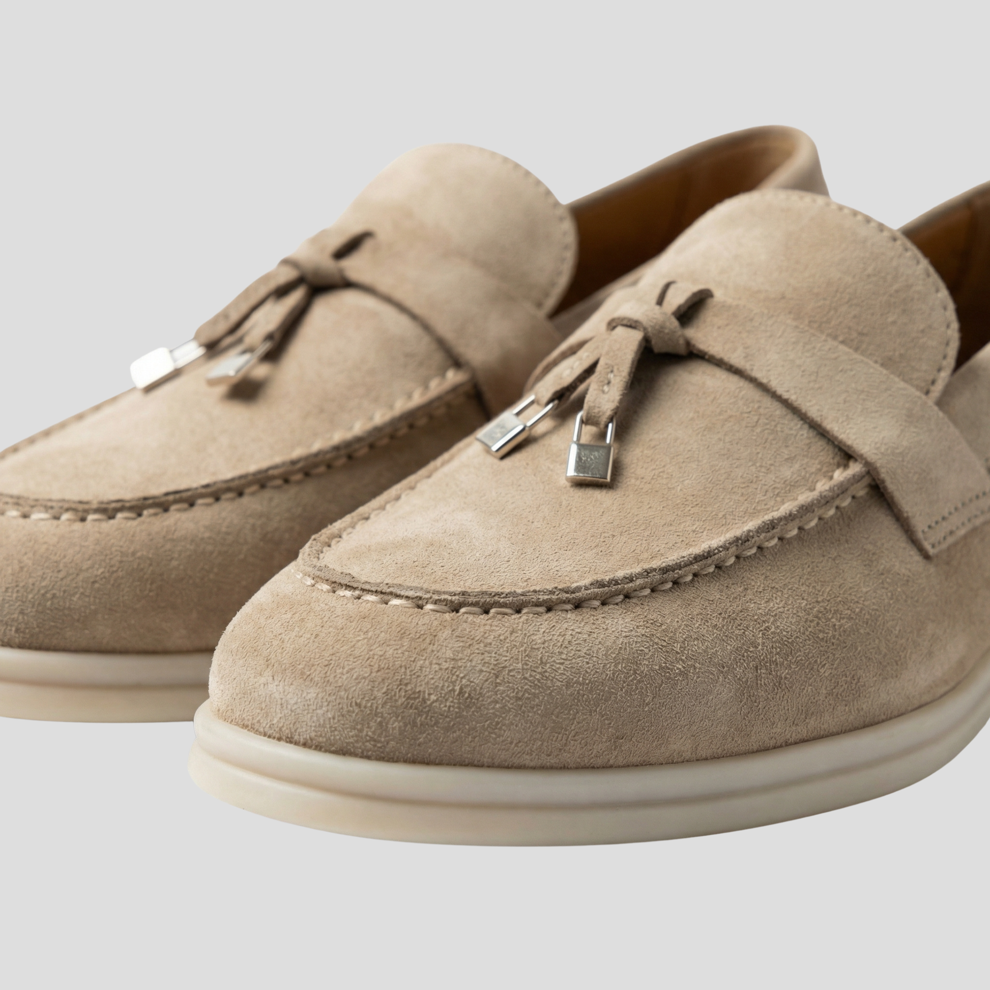 Women's tassel slip-on loafers with a clean silhouette, shown in a neutral colorway