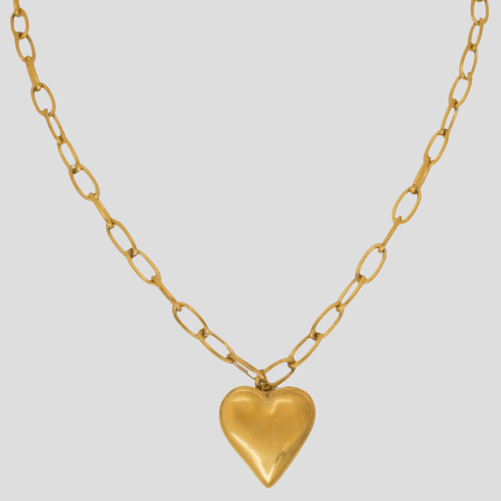 Gold-tone heart pendant necklace with a bold link chain silhouette