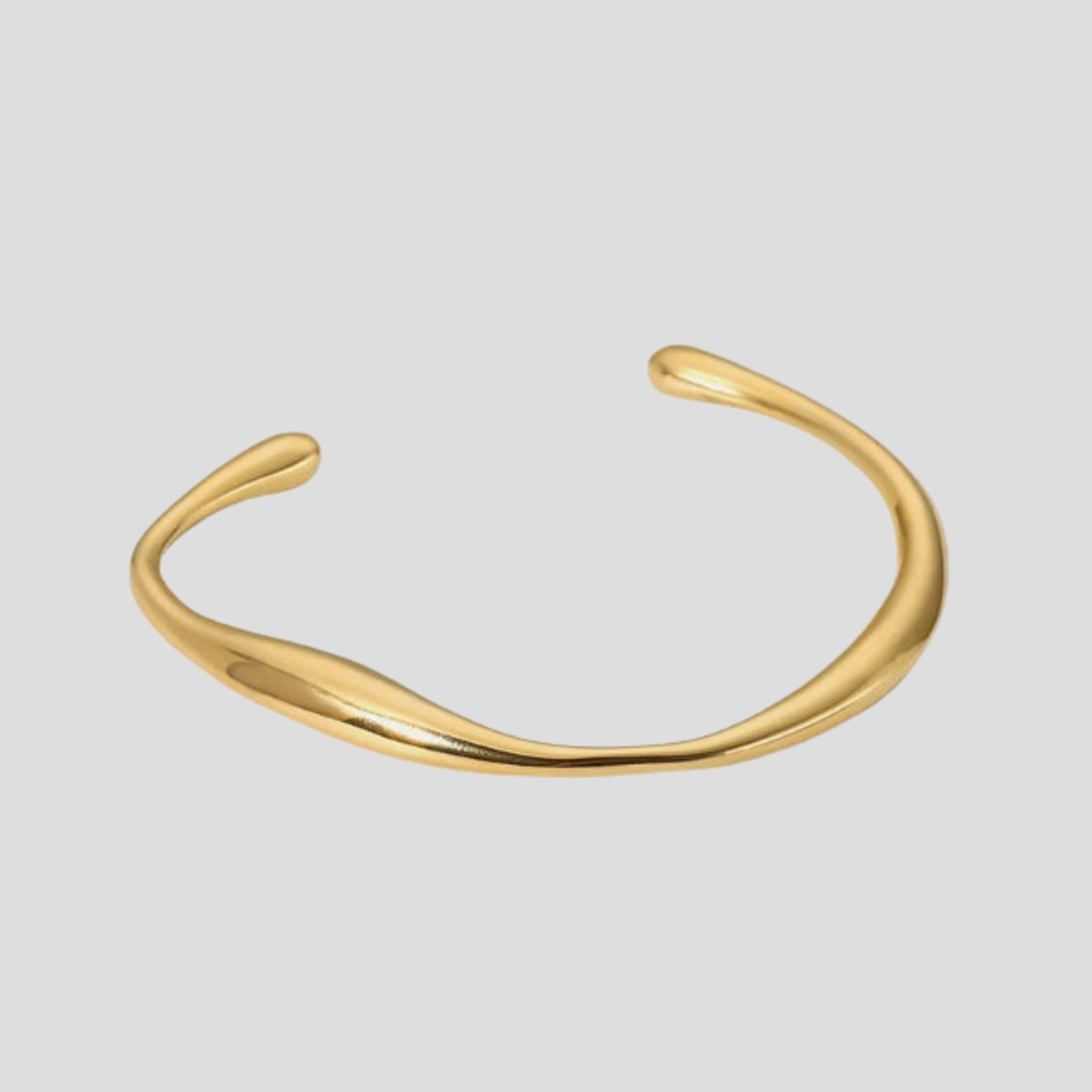 Gold open cuff bracelet with sculpted asymmetrical curve and rounded edges