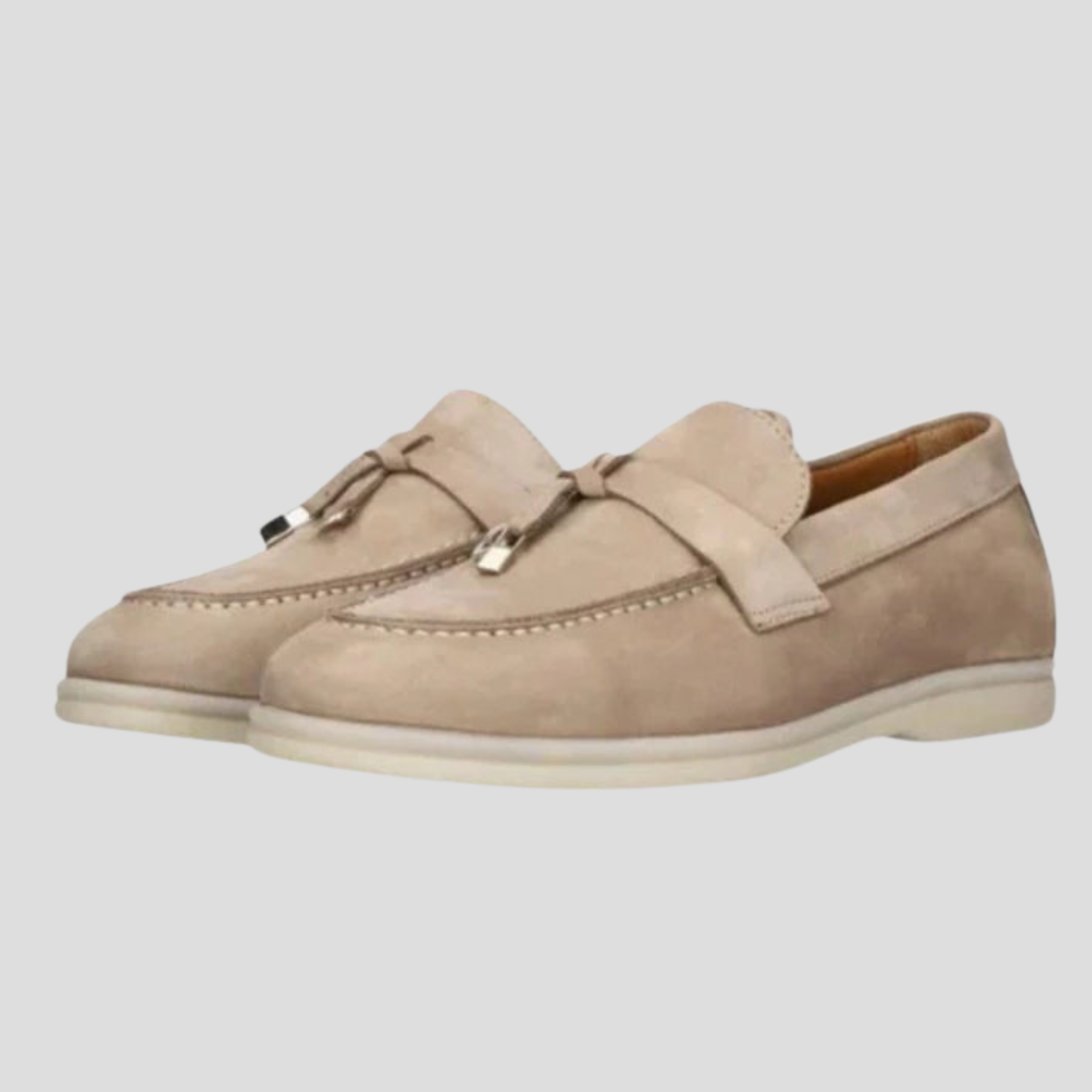 Women's tassel slip-on loafers with a clean silhouette, shown in a neutral colorway