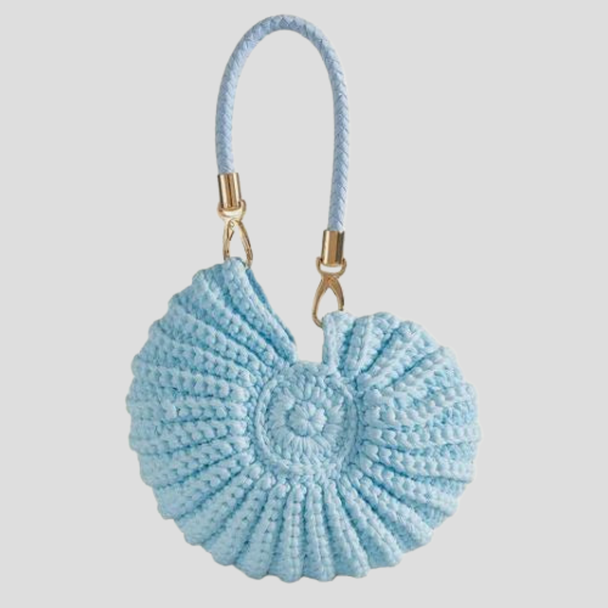 Conch-shaped woven handbag with sculptural silhouette, shown in blue, black, and white