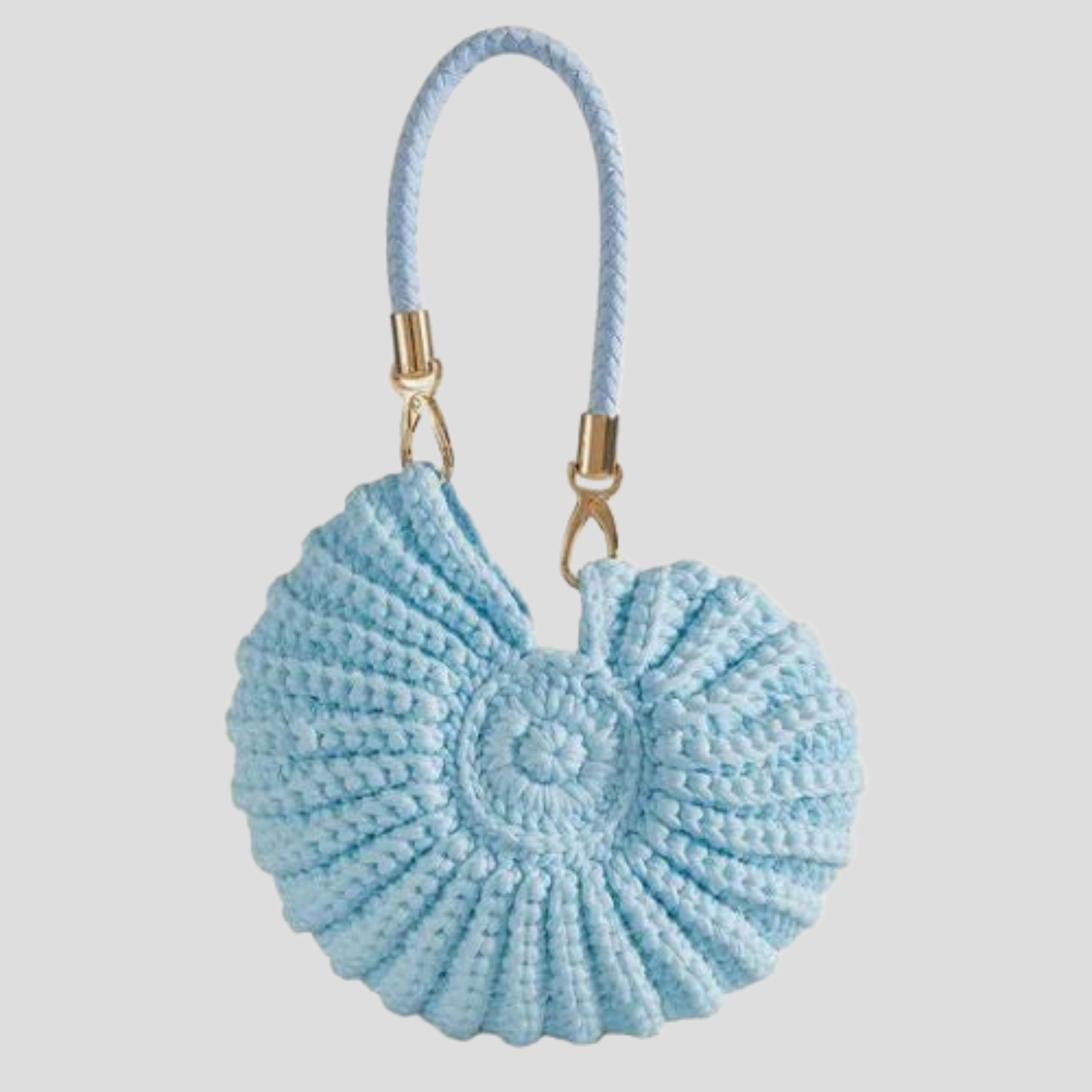 Conch-shaped woven handbag with sculptural silhouette, shown in blue, black, and white