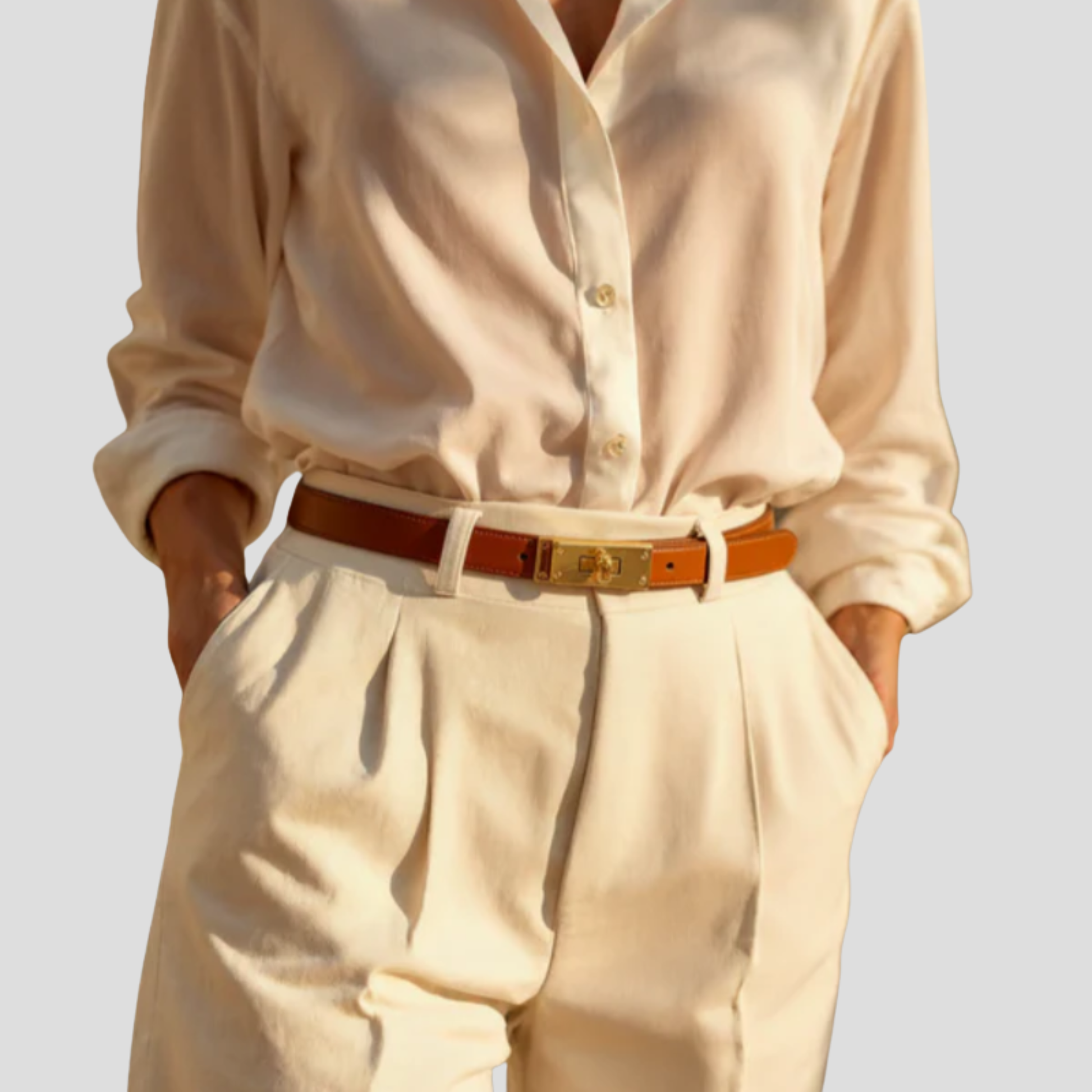 Women's straight-strap belt with a defined buckle, shown in neutral colors