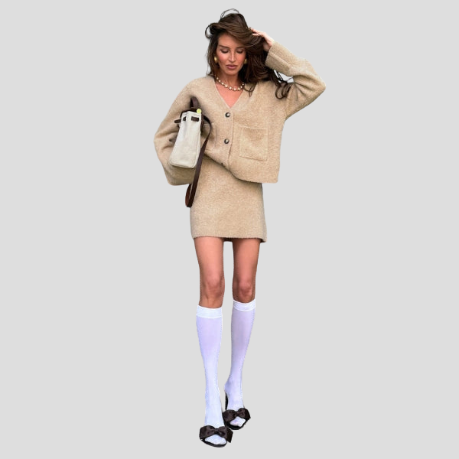 Beige women's two-piece set with V-neck cardigan and coordinated mini skirt