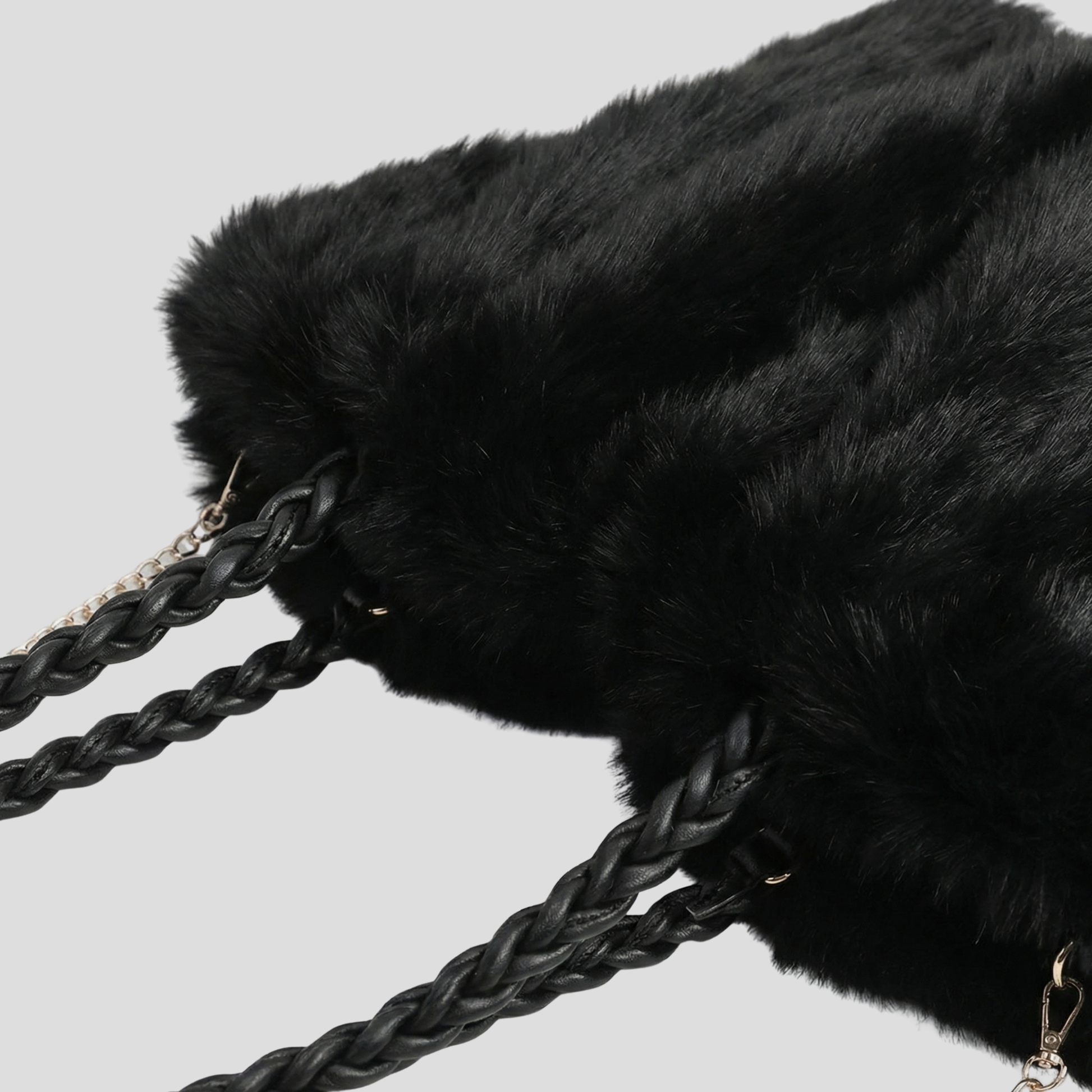 Oversized tote bag with braided handle detail, shown in black, brown, and beige