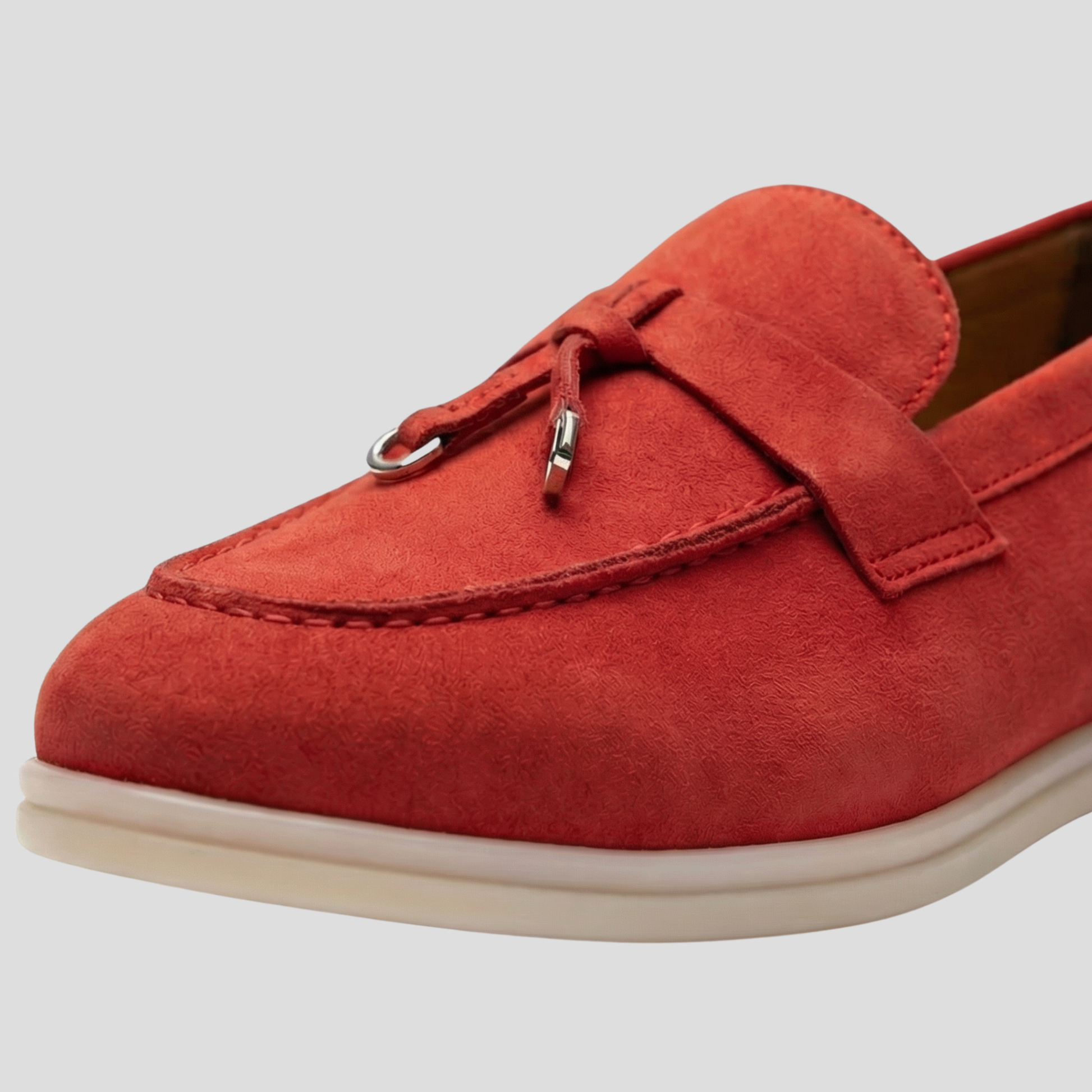 Women's tassel slip-on loafers with a clean silhouette, shown in a neutral colorway