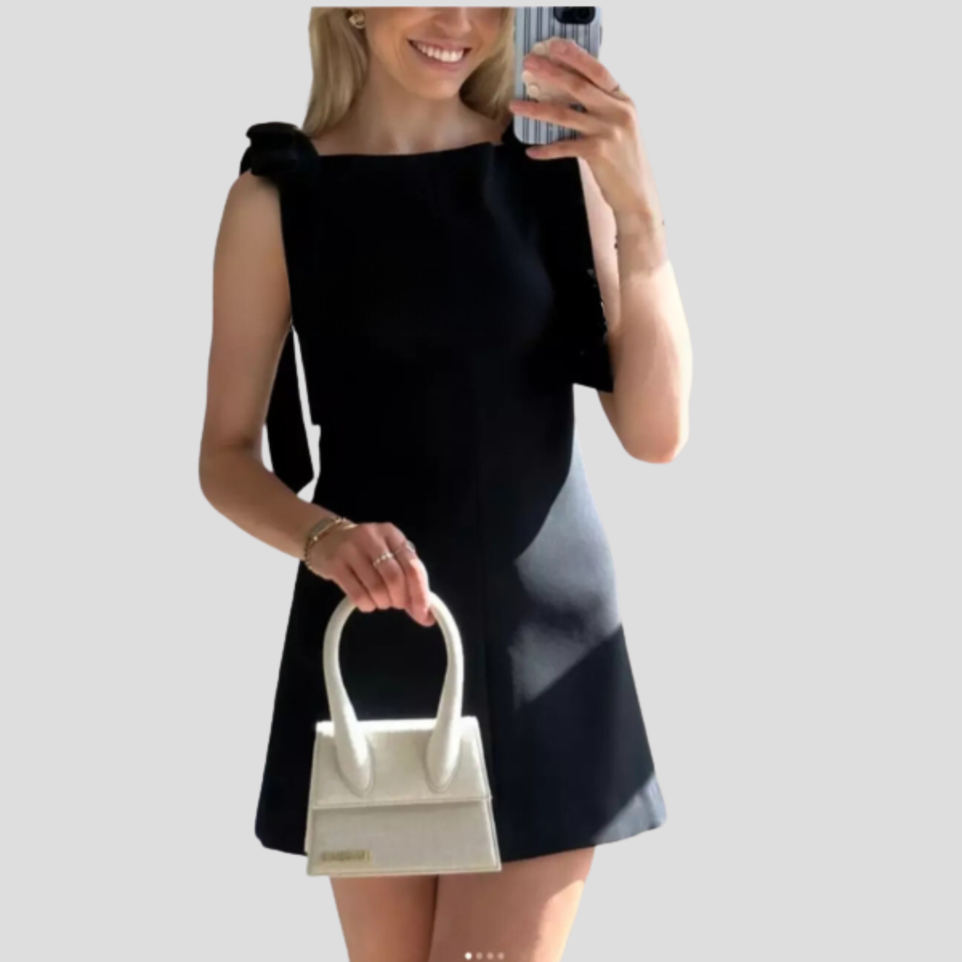 Black bow strap mini dress with A-line silhouette for evening wear