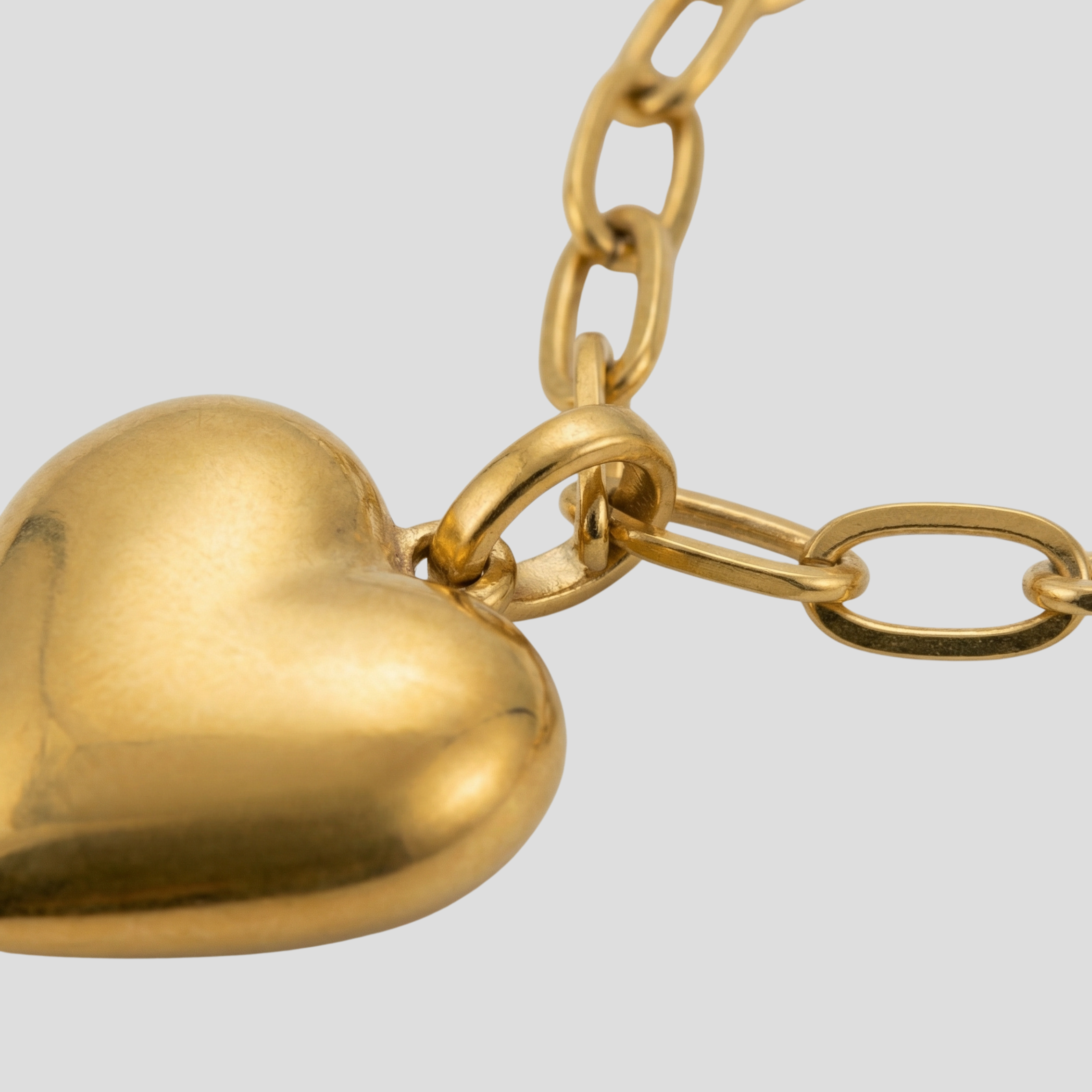Gold-tone heart pendant necklace with a bold link chain silhouette
