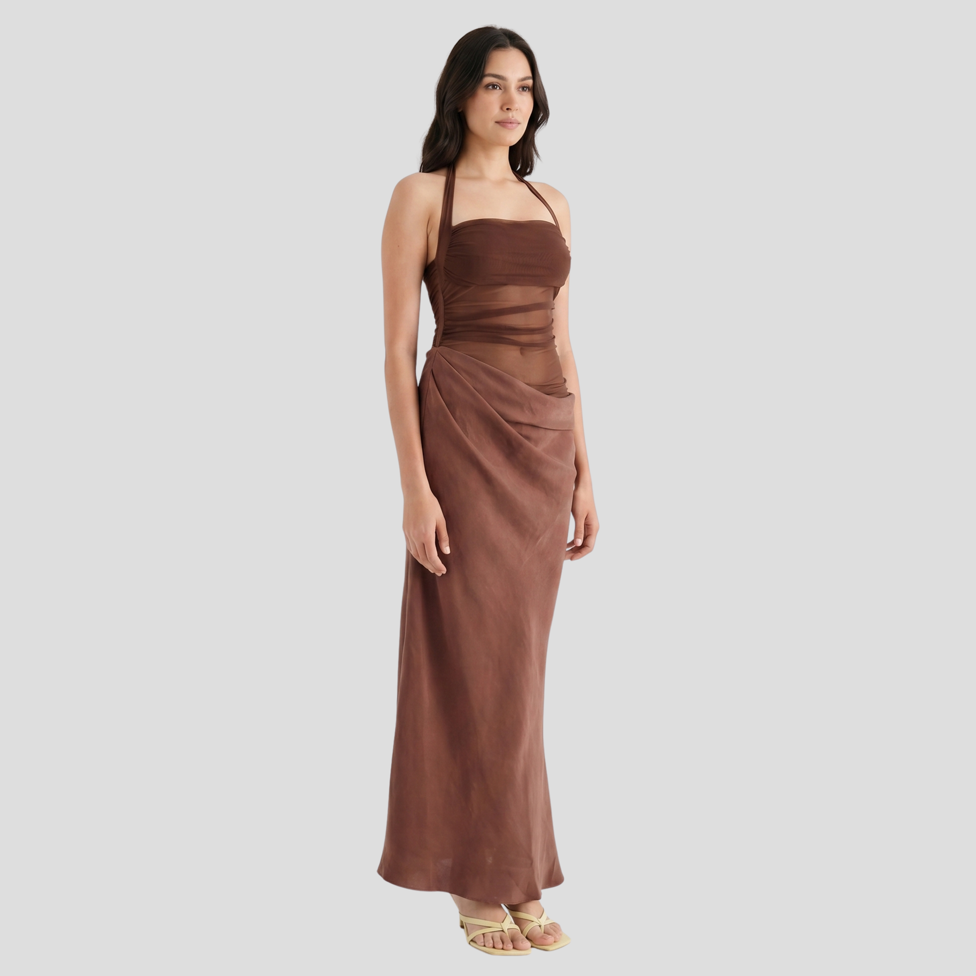 Brown maxi dress with sheer panel detailing and a draped flowing skirt