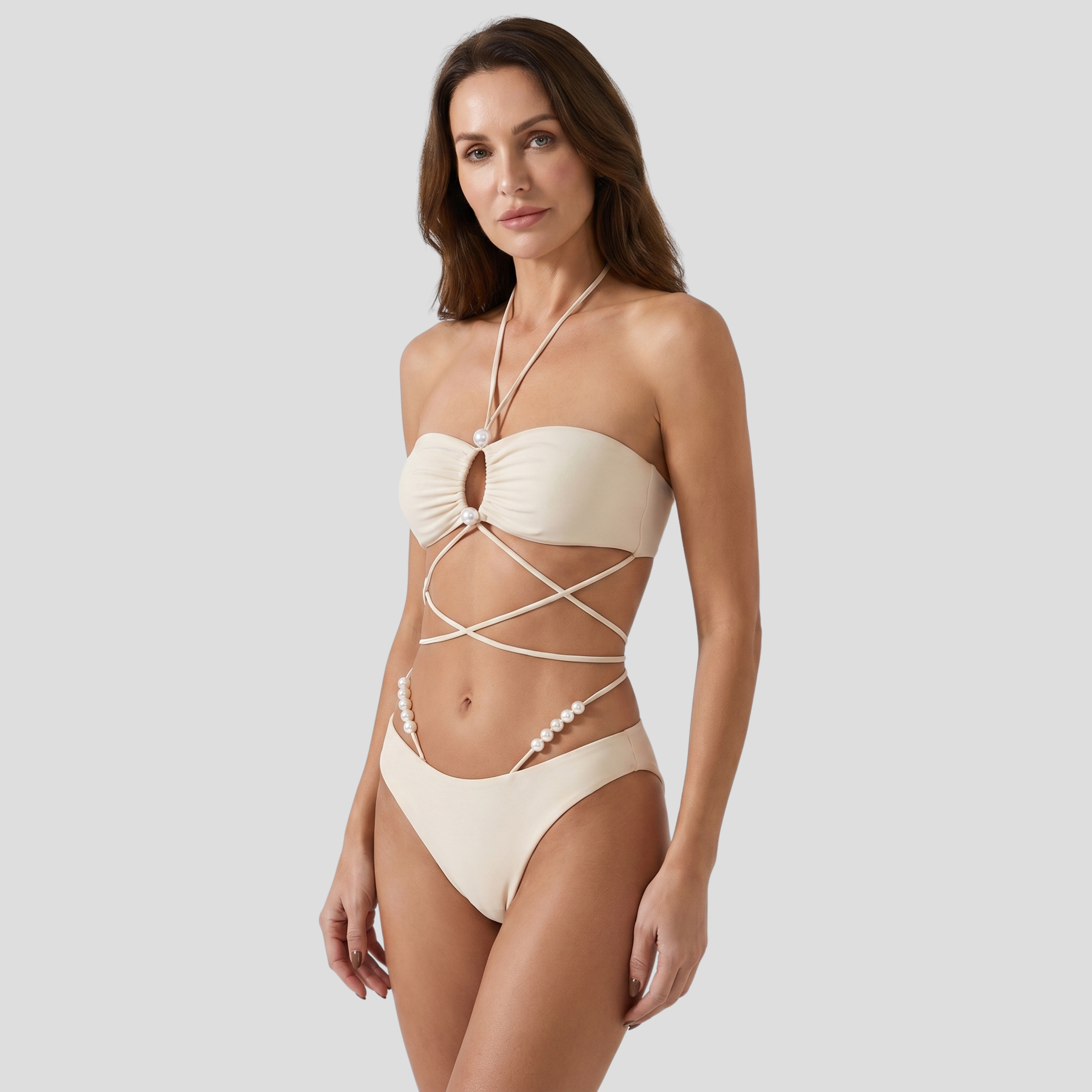 White women's bikini set with pearl details and wrap-tie top and bottom