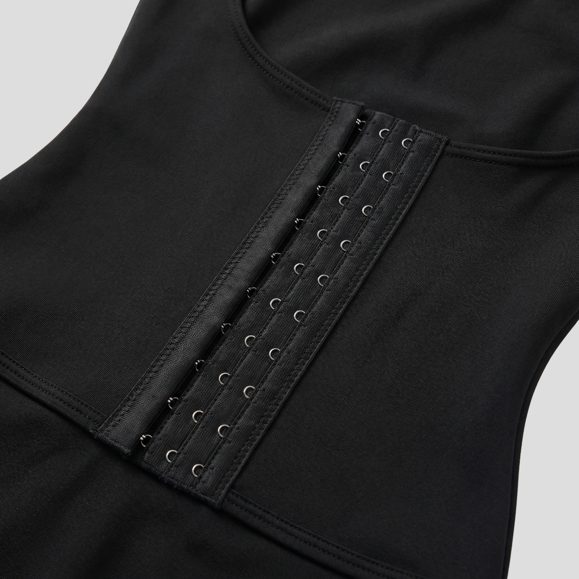 Women's sleeveless ribbed bodysuit with hook-front closure in black and beige