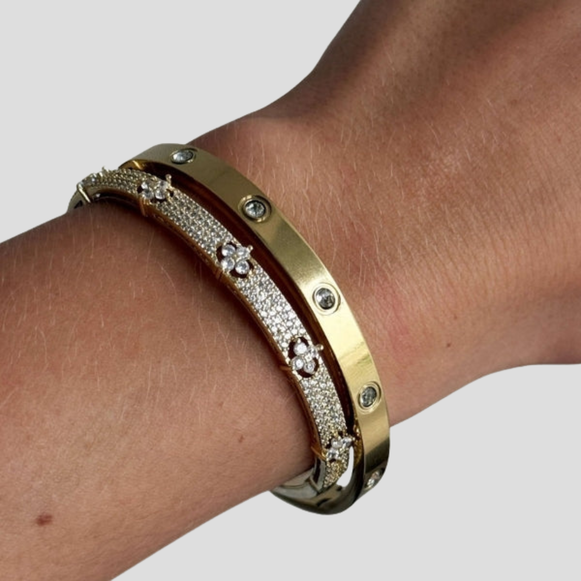 Hinged women's cuff bracelet with pavé panel detail in gold and silver tones