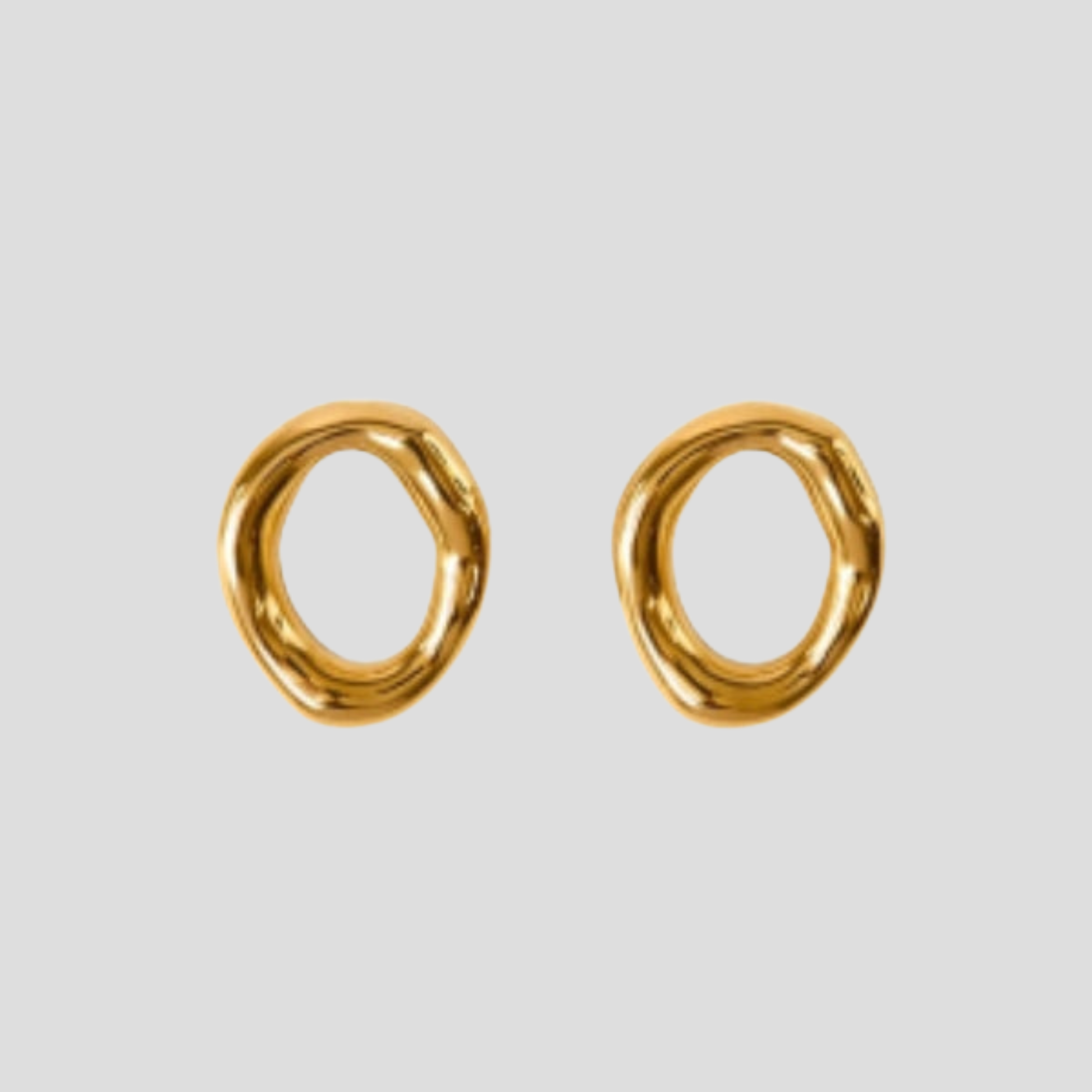 Gold-tone sculptural oval drop earrings with a smooth polished outline