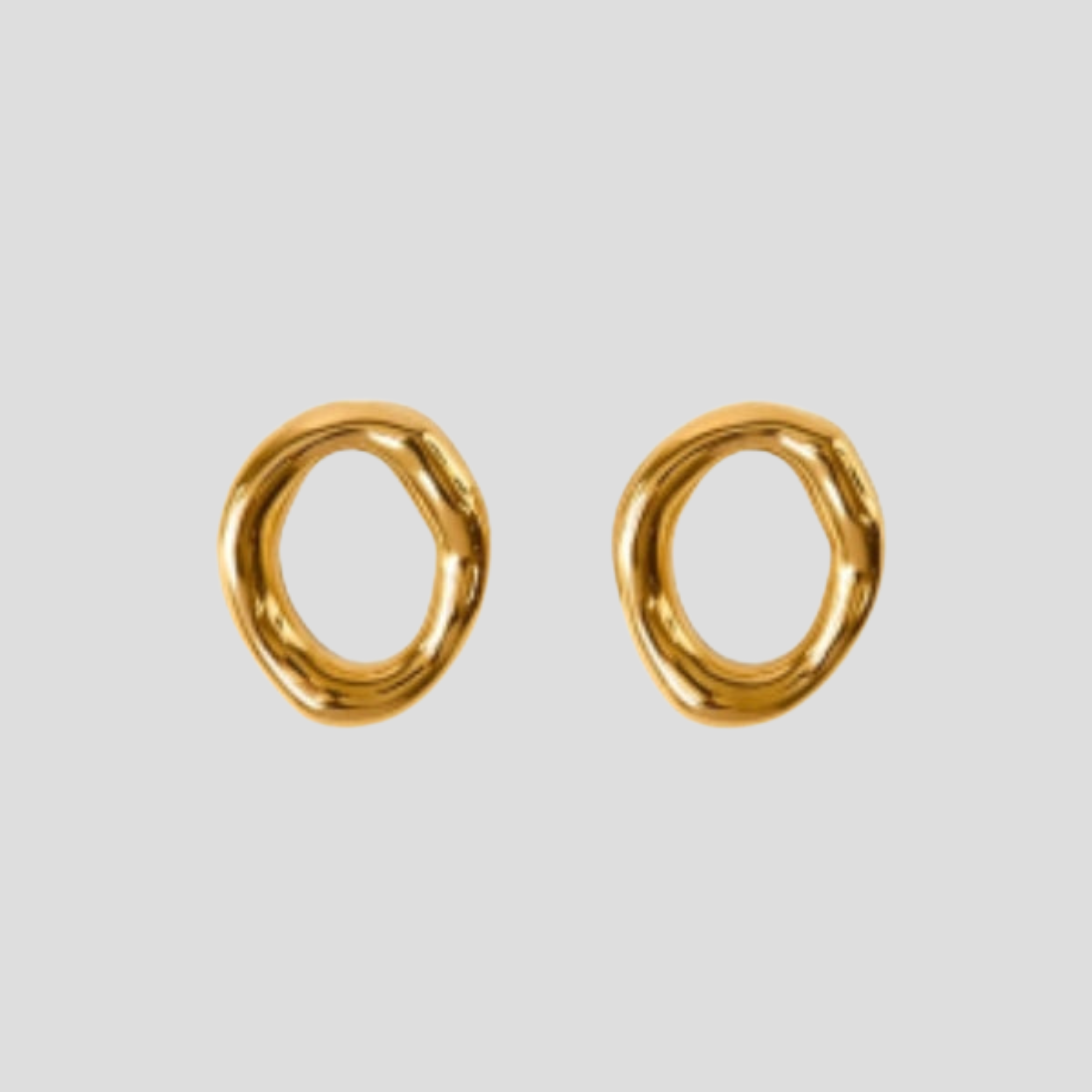Gold-tone sculptural oval drop earrings with a smooth polished outline