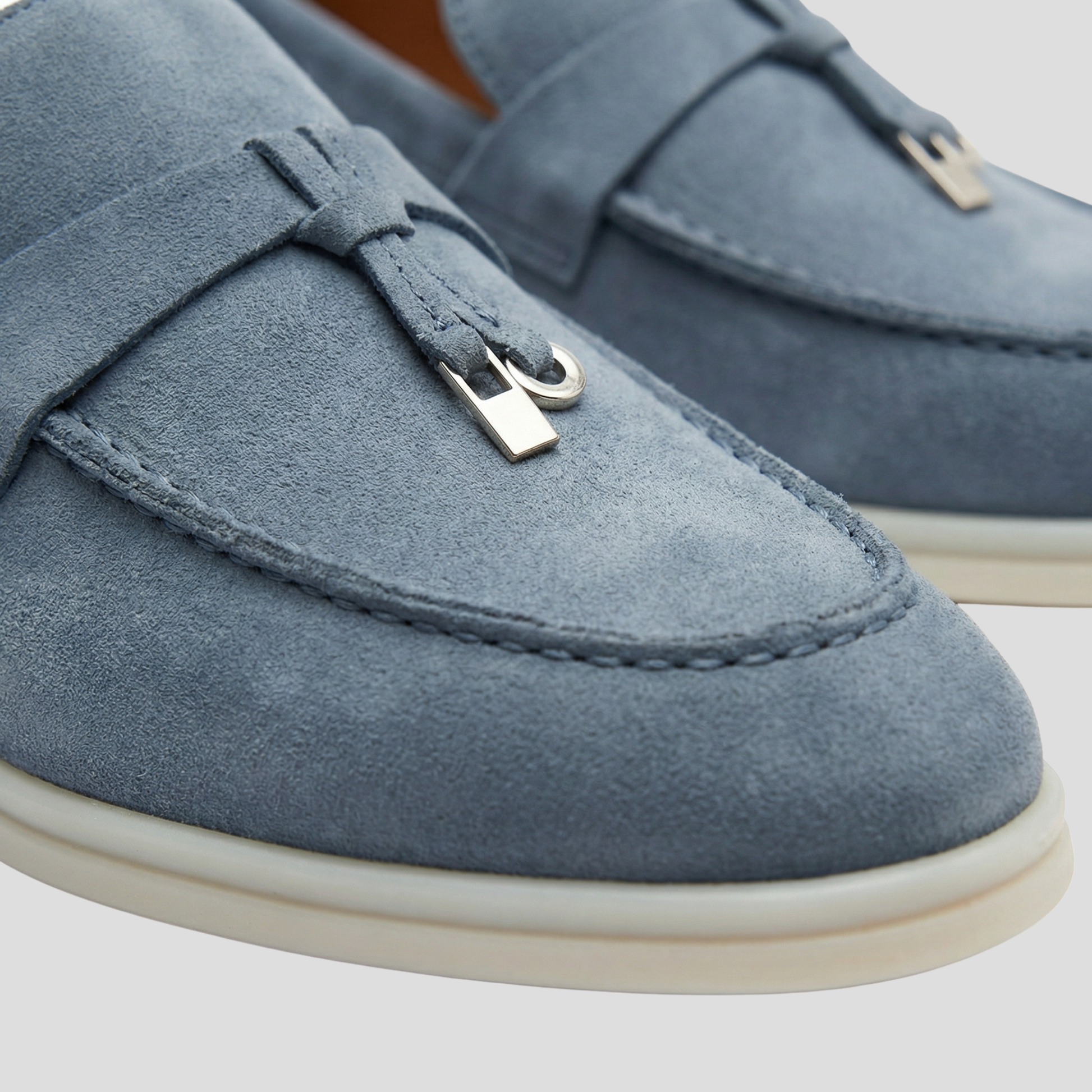 Women's tassel slip-on loafers with a clean silhouette, shown in a neutral colorway