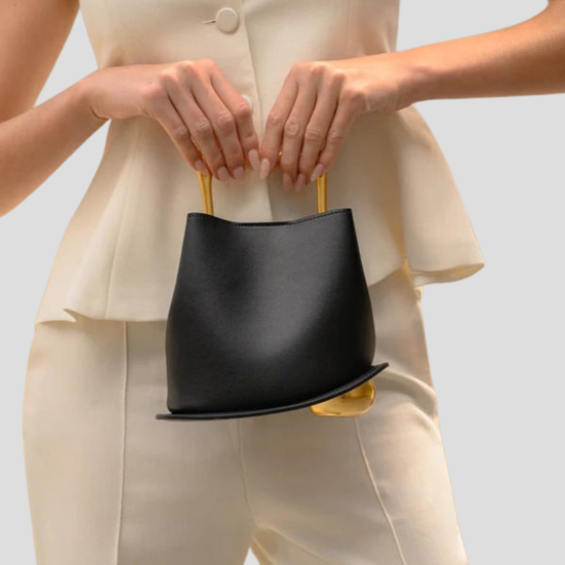 Rounded mini handbag with sculpted handle shown in neutral colorways