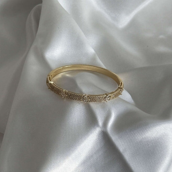 Hinged women's cuff bracelet with pavé panel detail in gold and silver tones