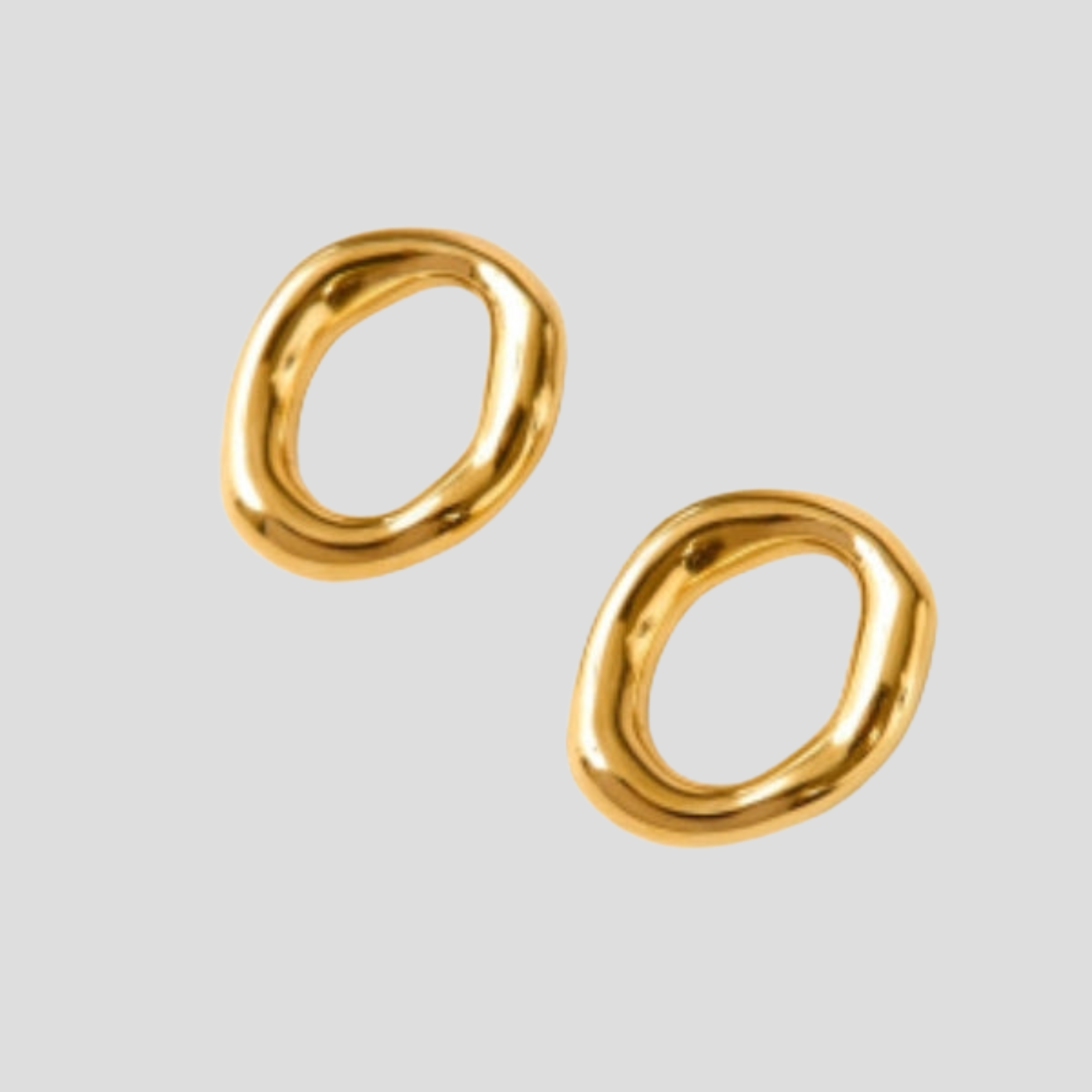 Gold-tone sculptural oval drop earrings with a smooth polished outline