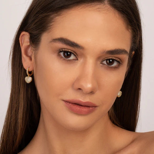 Heart charm pavé drop earrings shown in gold and silver finishes
