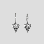 Sculpted heart-shaped earrings with a polished silver finish for women