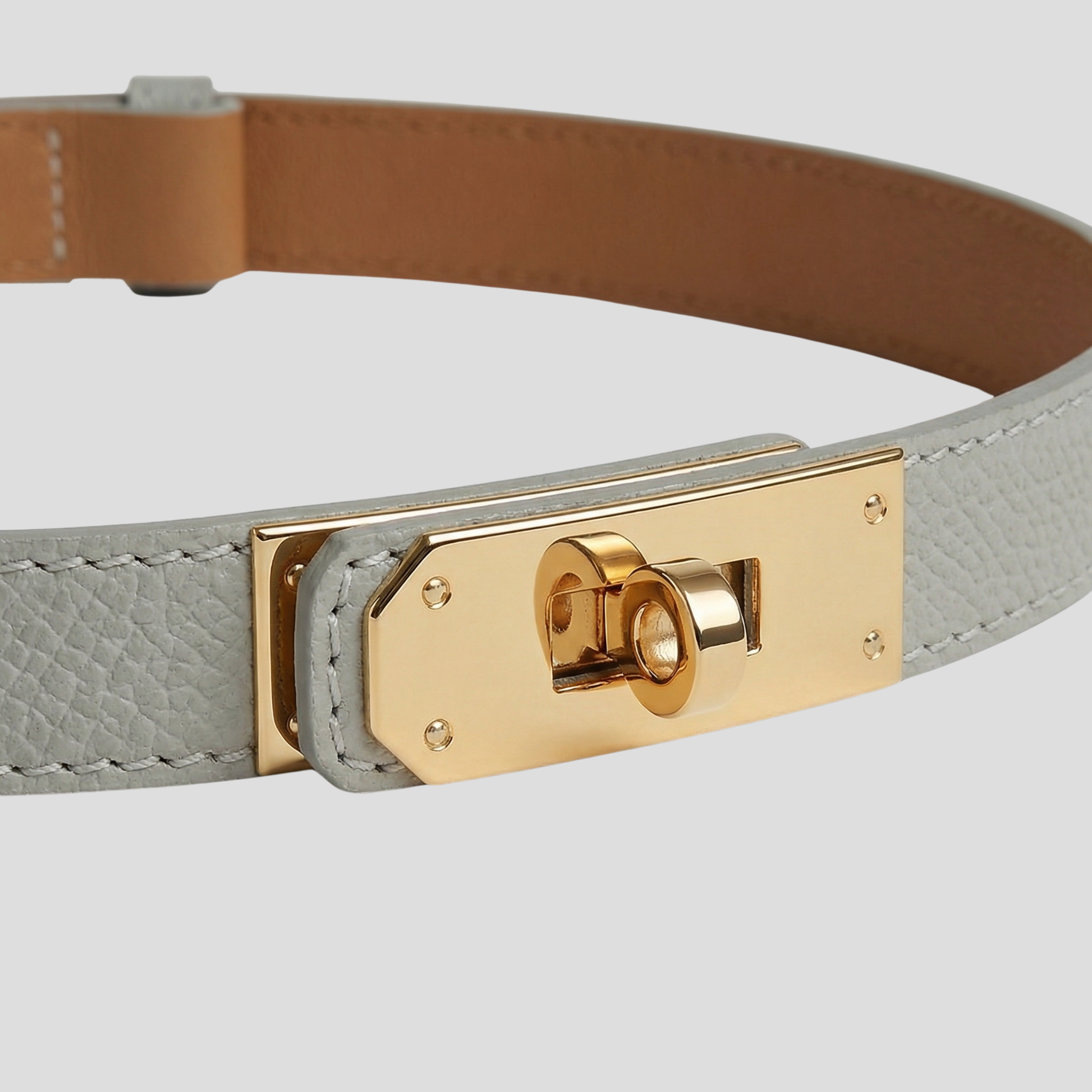 Women's straight-strap belt with a defined buckle, shown in neutral colors