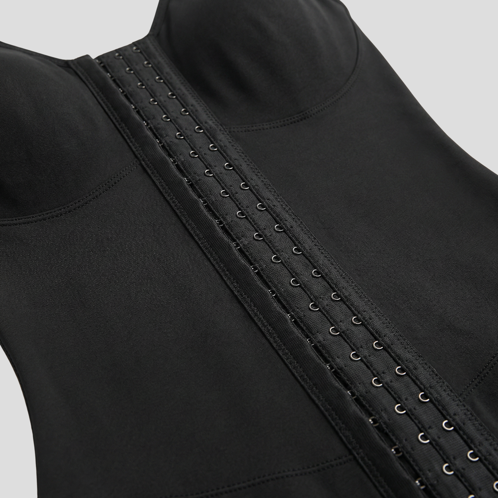 Women's full-length sculpting bodysuit with hook-front closure in black and beige