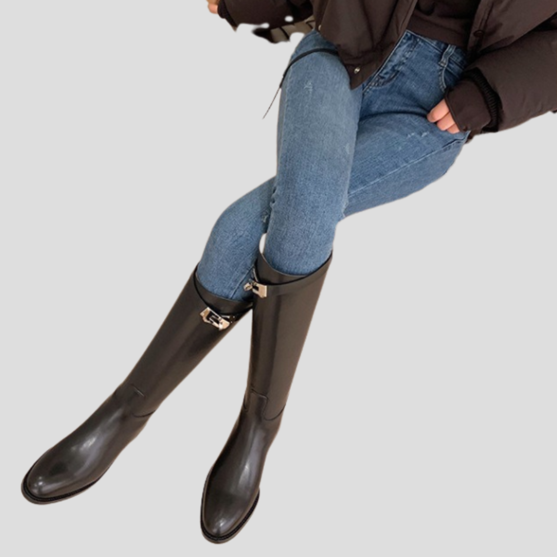 Black knee-high boots with buckle detail on the shaft and a rounded toe