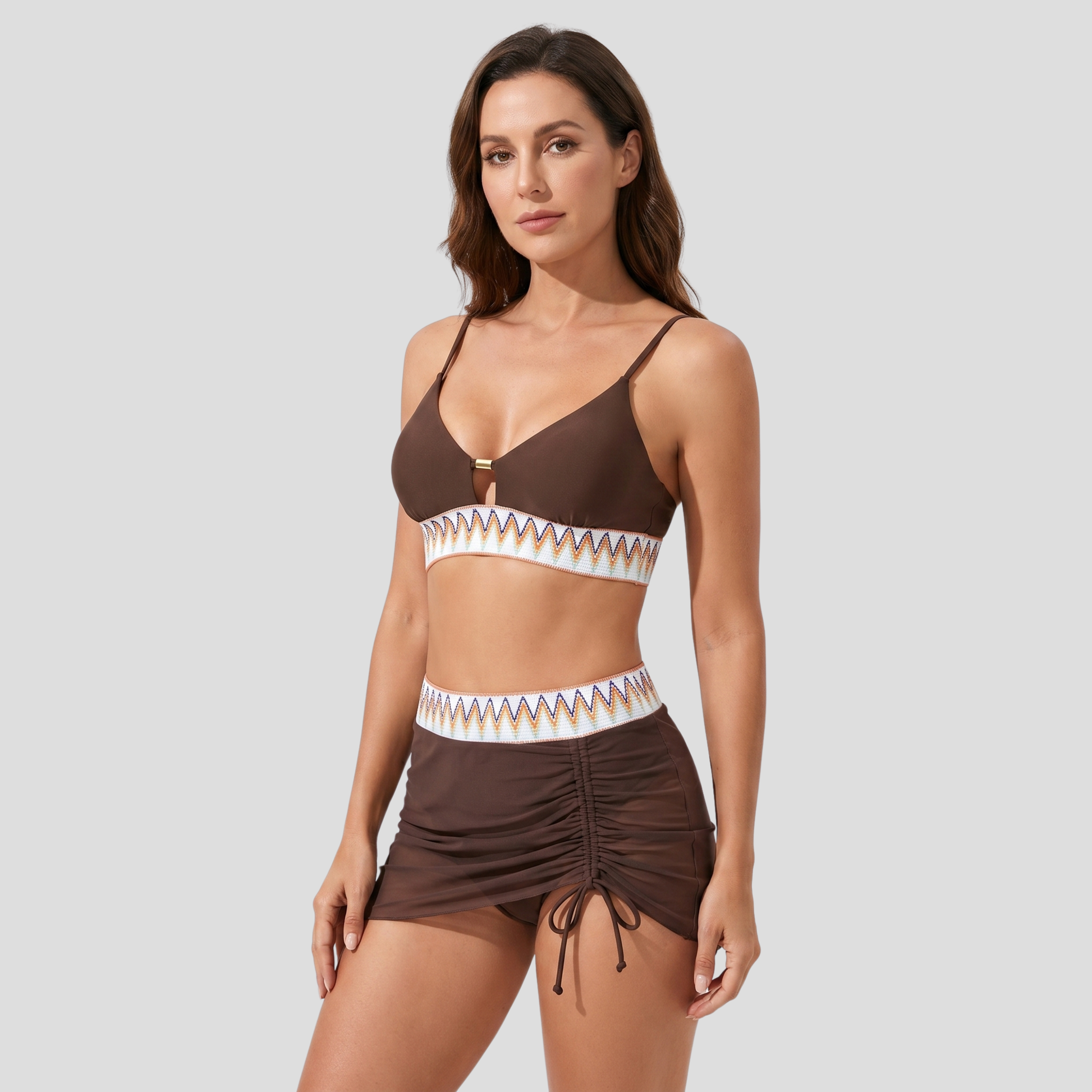 Women's three-piece swimwear set with embroidered waistband, metallic detail, and sheer tulle skirt