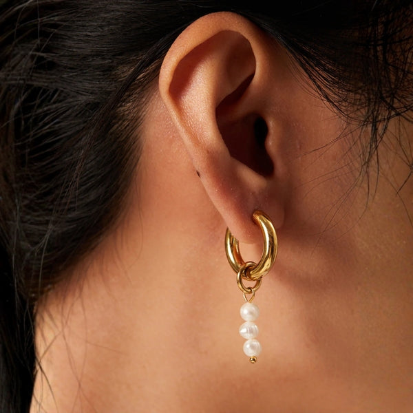 Gold-tone mismatched hoop earrings with delicate bead drop detail for women