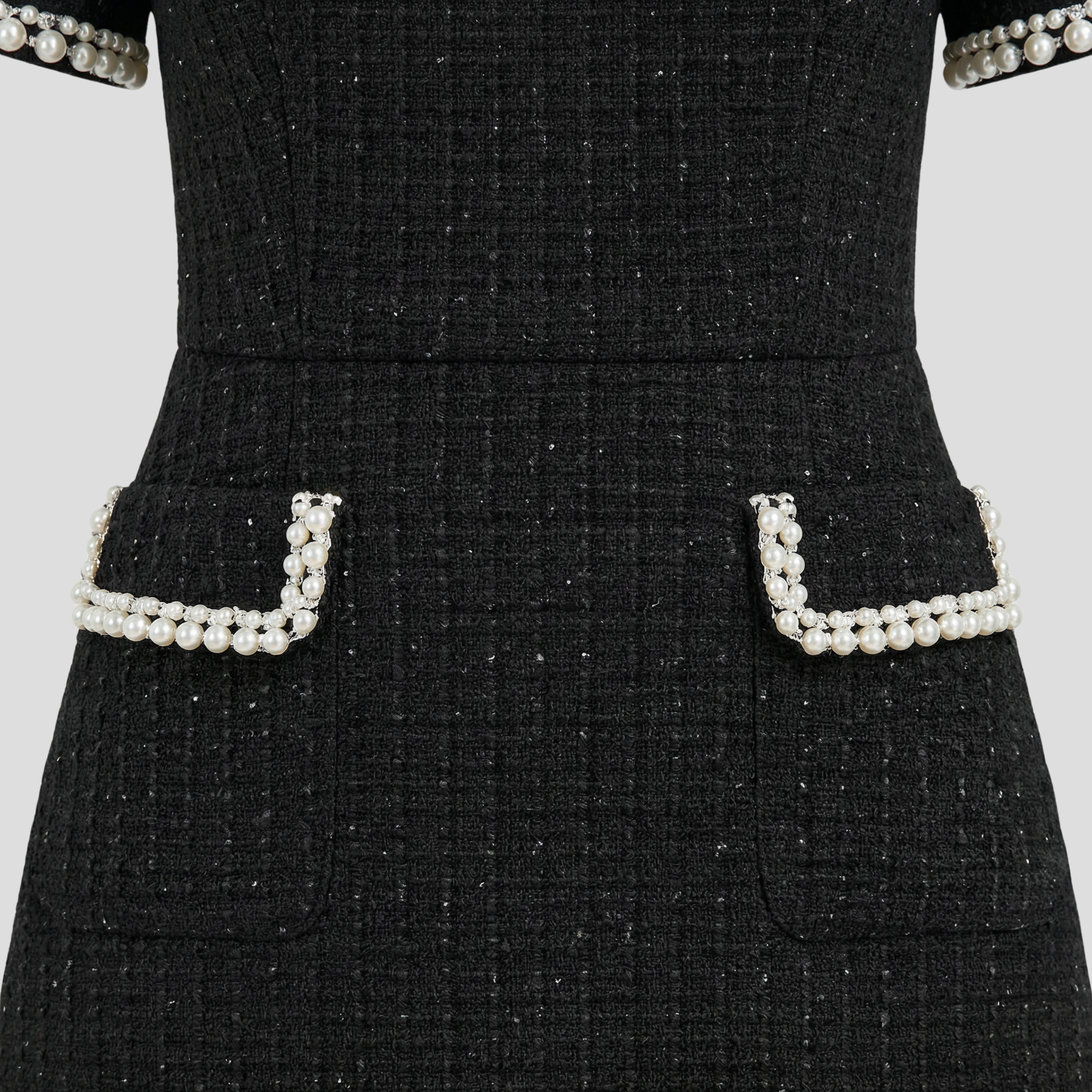 Structured mock neck mini dress with pearl-trim detailing in black and white