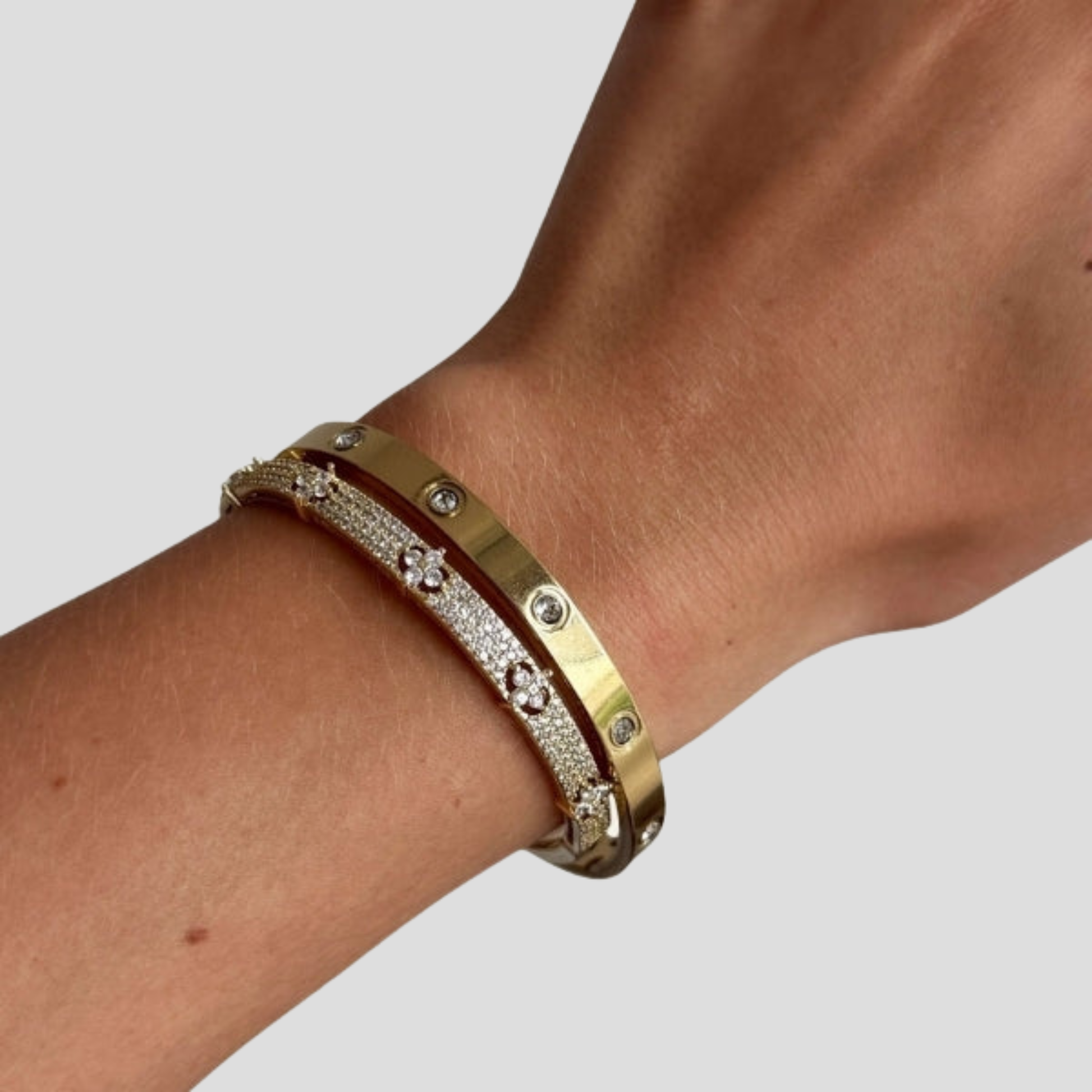 Hinged women's cuff bracelet with pavé panel detail in gold and silver tones