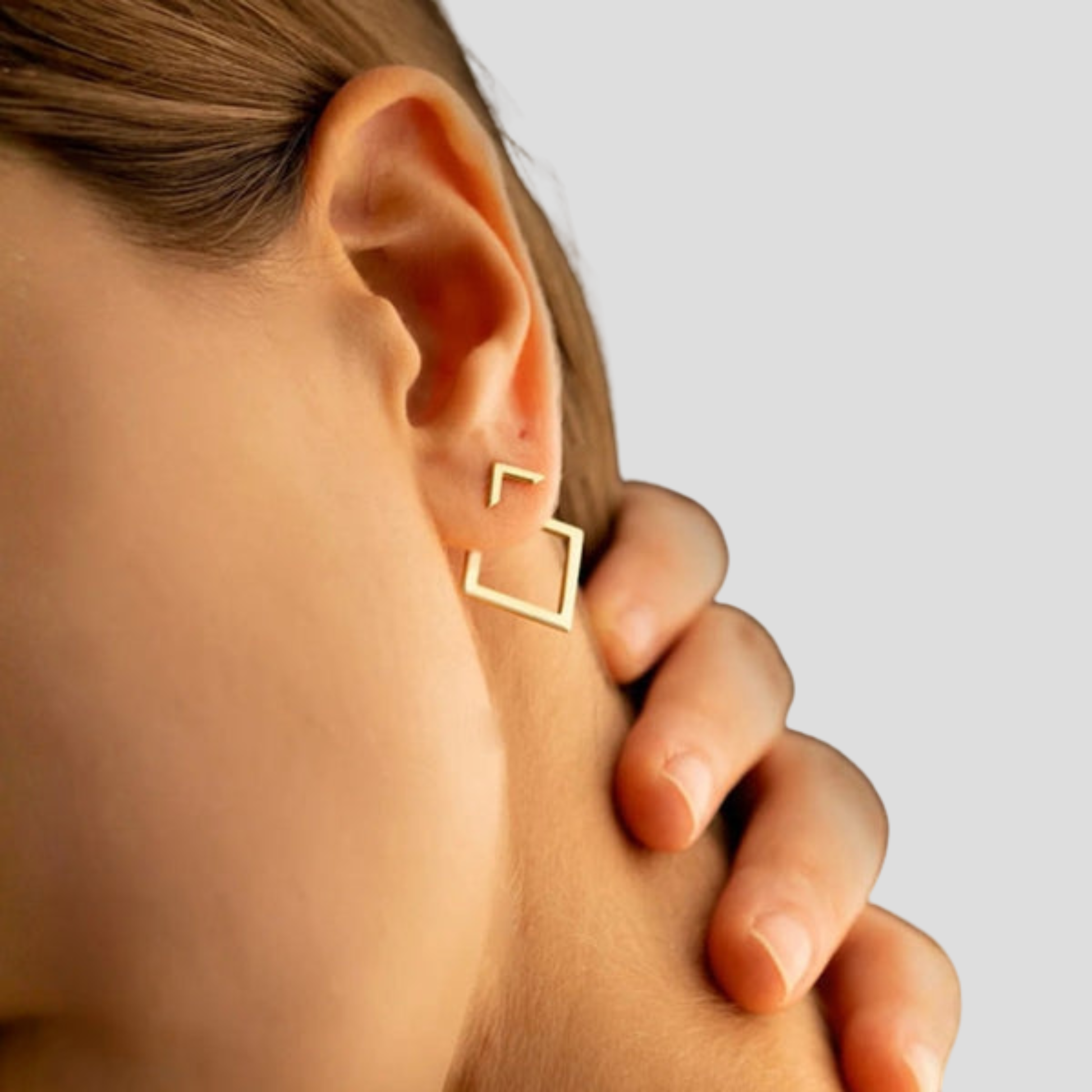 Gold-tone drop earrings with chevron stud and open square drop design