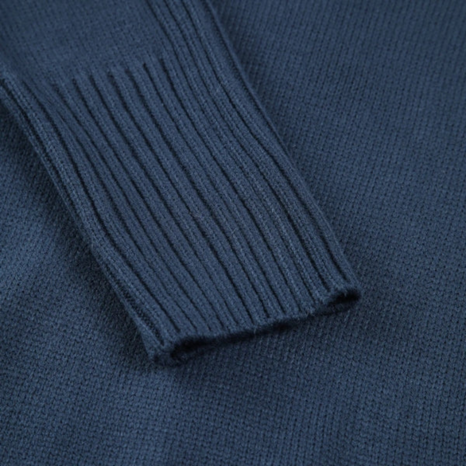 Navy blue ribbed high neck sweater with relaxed silhouette and extended cuffs