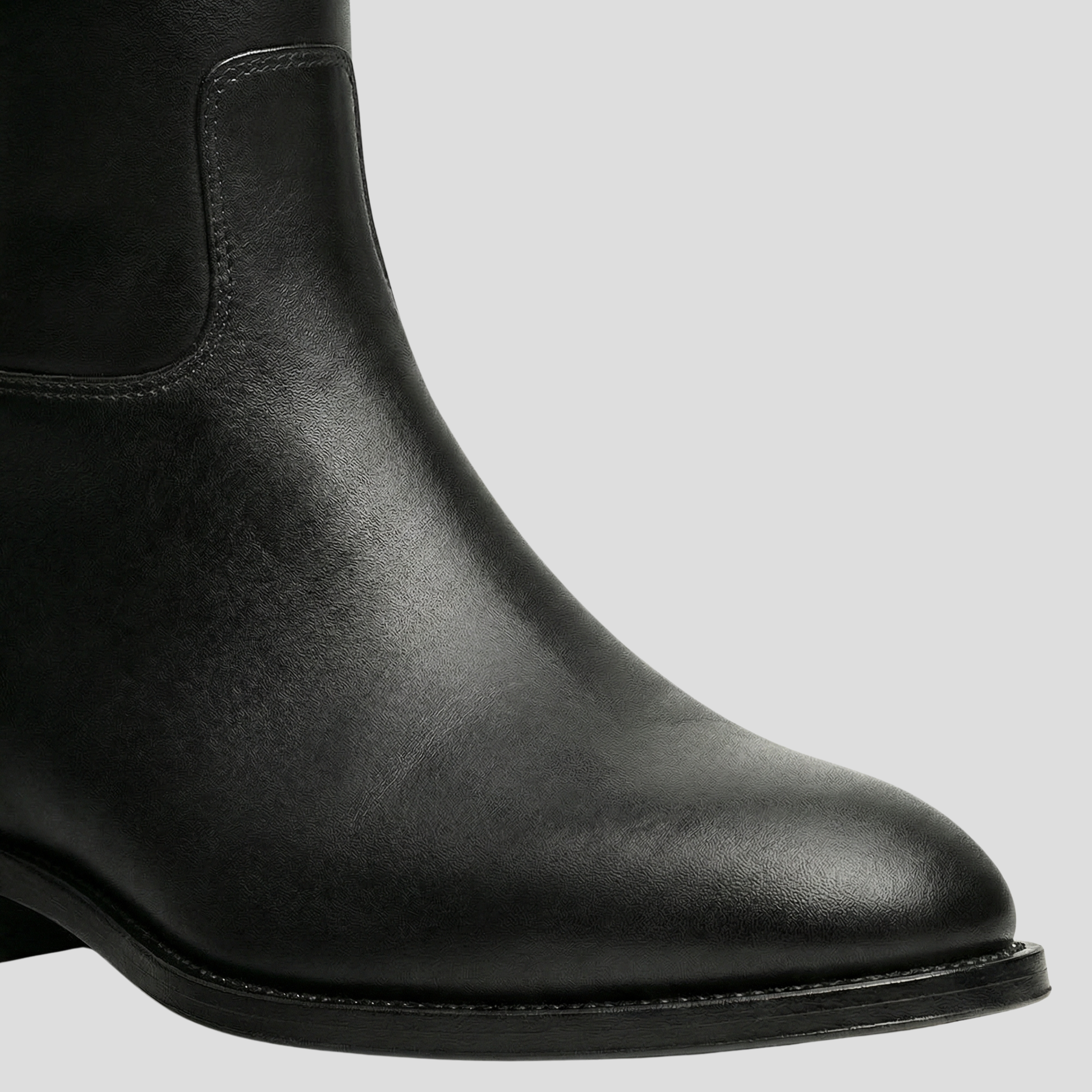 Black knee-high boots with buckle detail on the shaft and a rounded toe