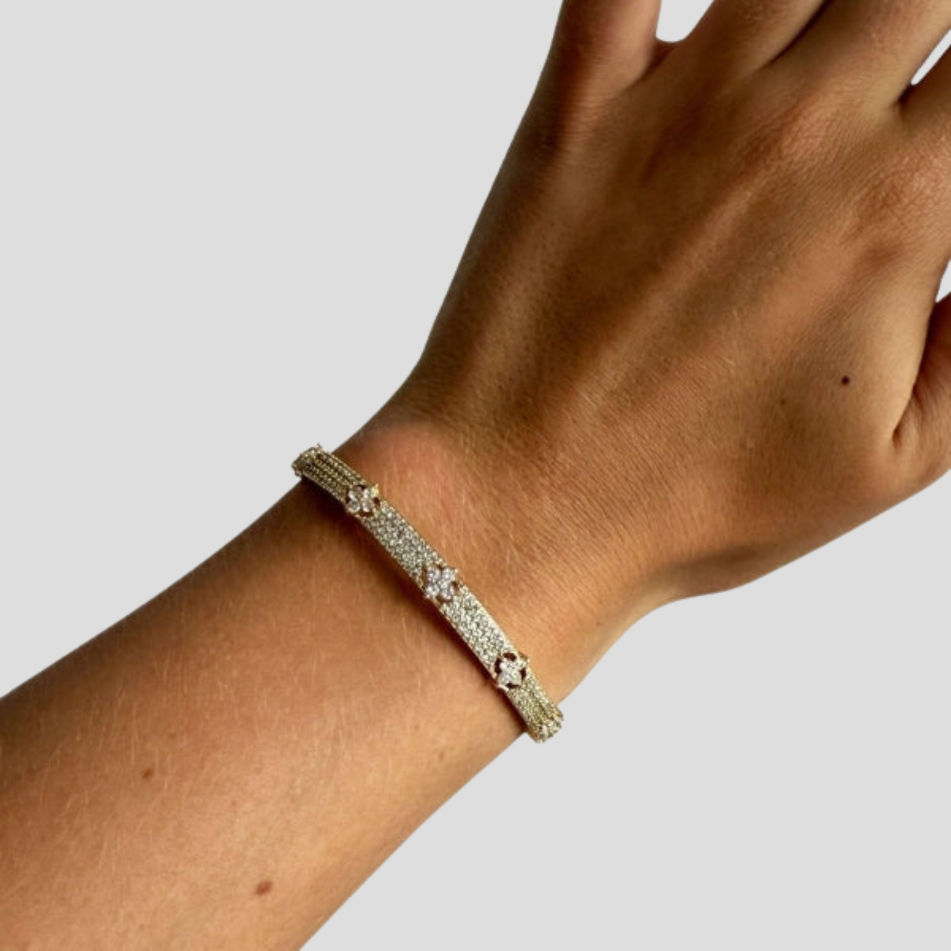 Hinged women's cuff bracelet with pavé panel detail in gold and silver tones
