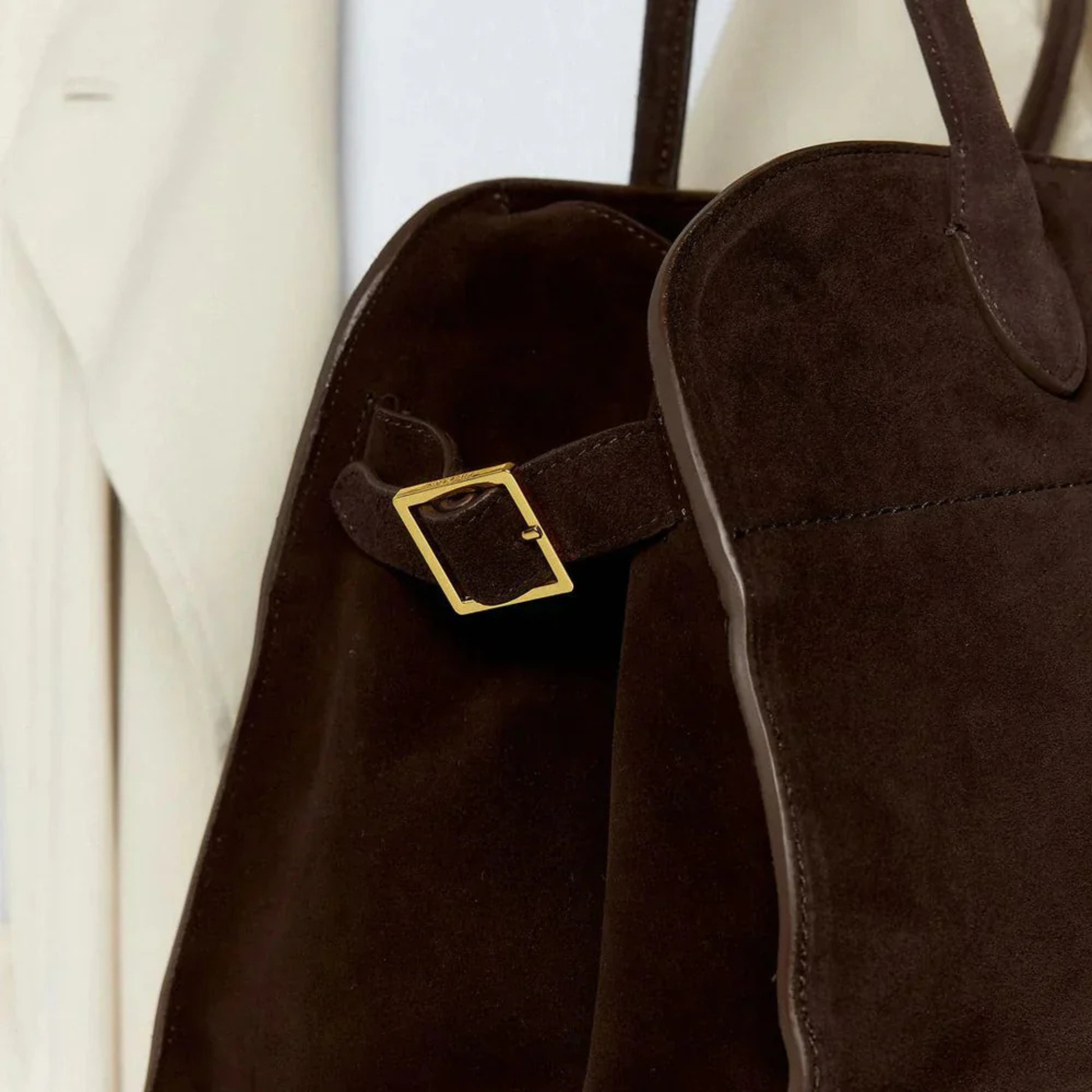Brown structured everyday handbag with front buckle accent