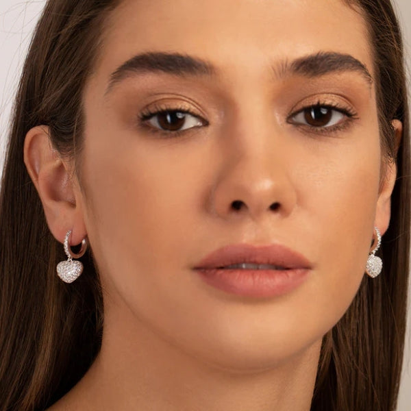 Heart charm pavé drop earrings shown in gold and silver finishes