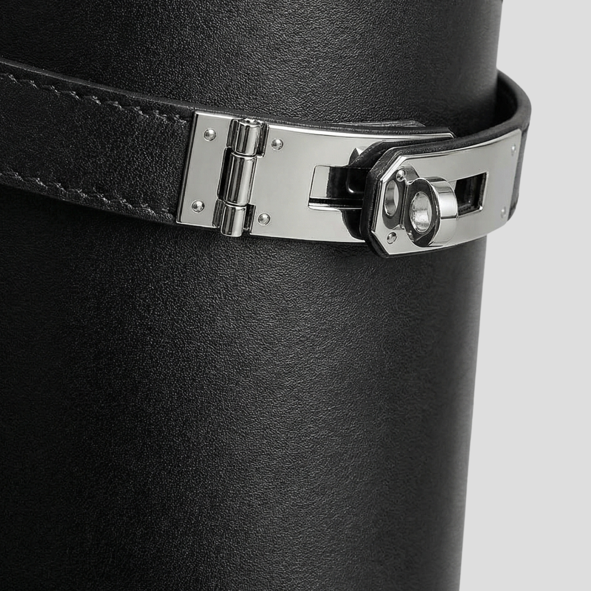 Black knee-high boots with buckle detail on the shaft and a rounded toe