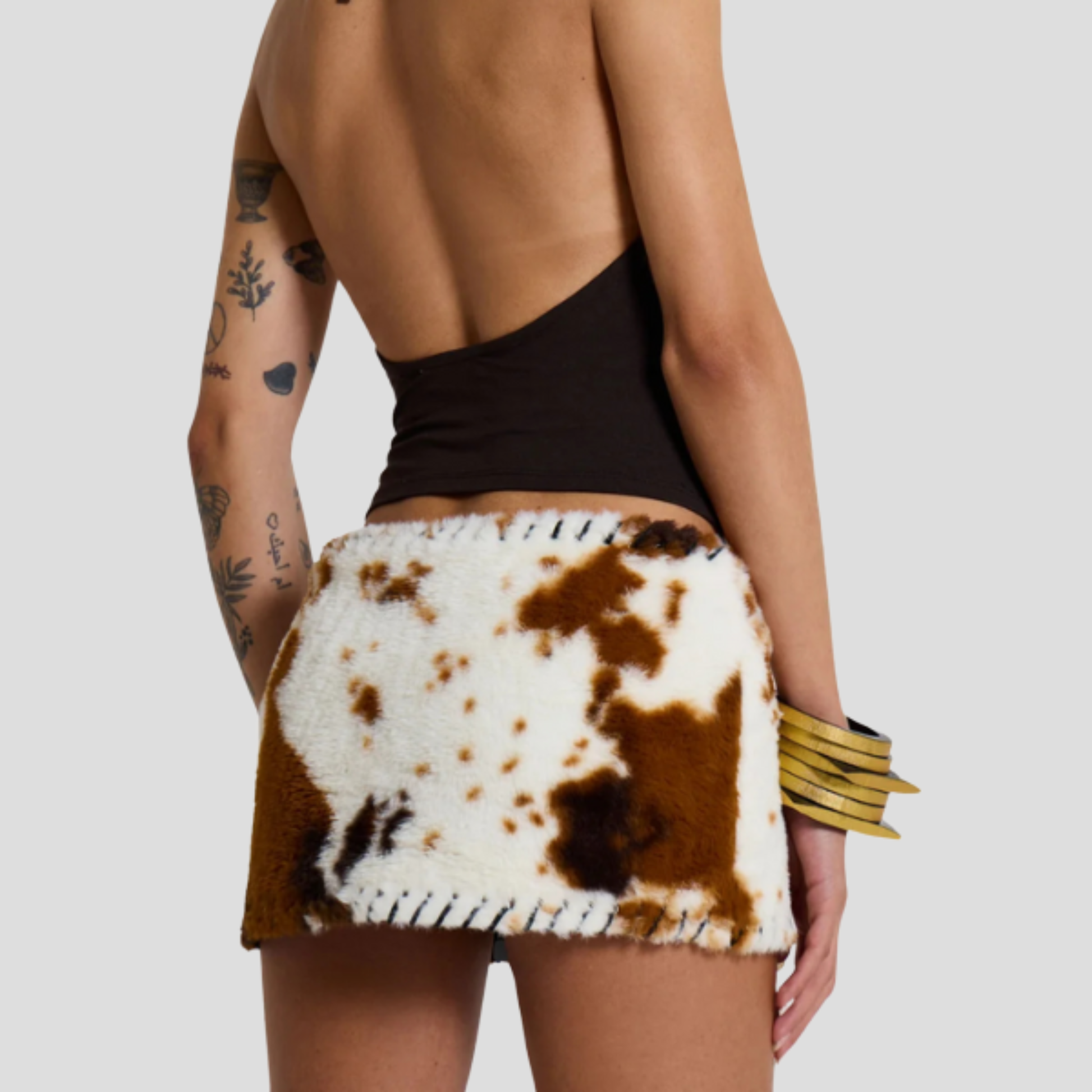 Brown cow print micro mini skirt with whipstitch edge detail