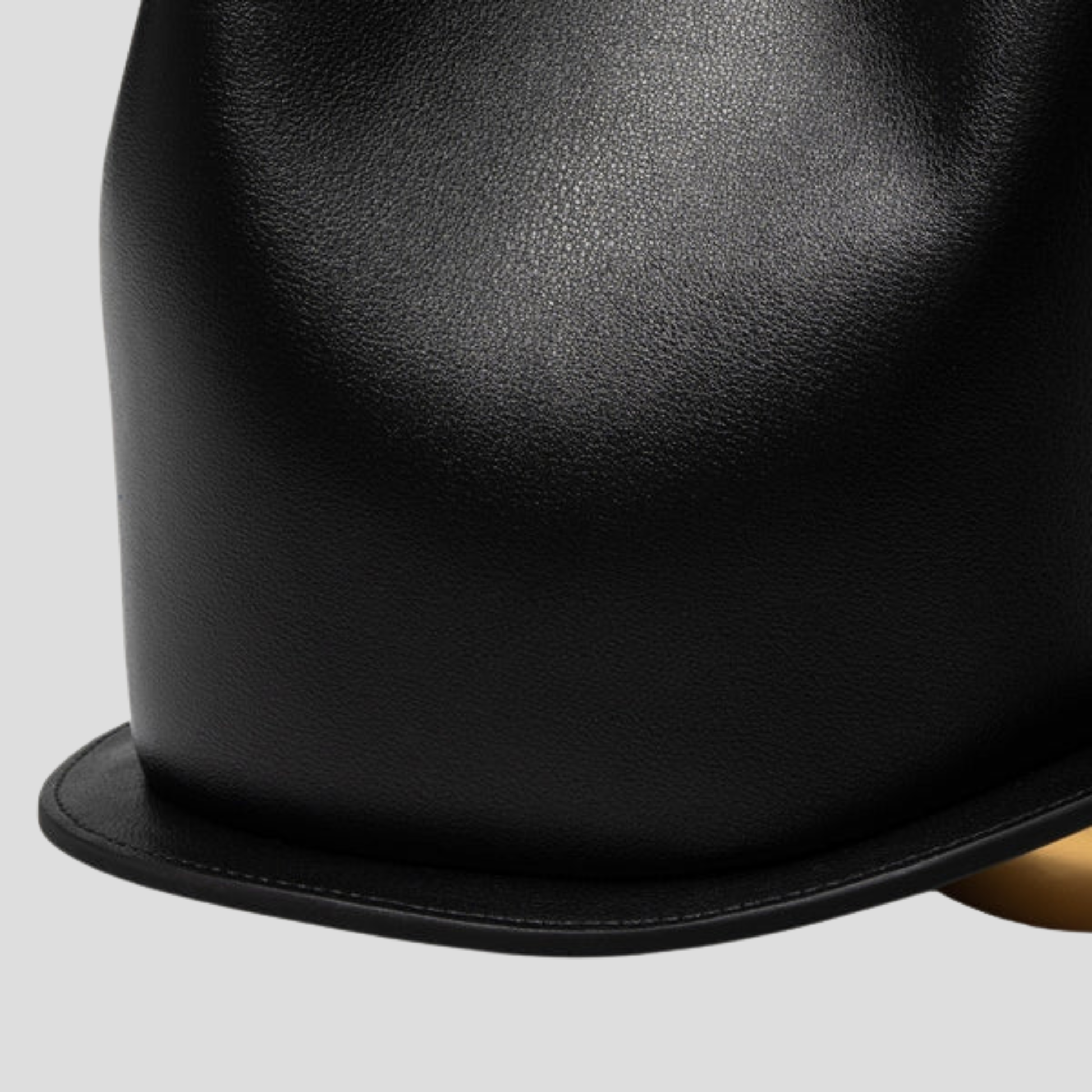 Rounded mini handbag with sculpted handle shown in neutral colorways