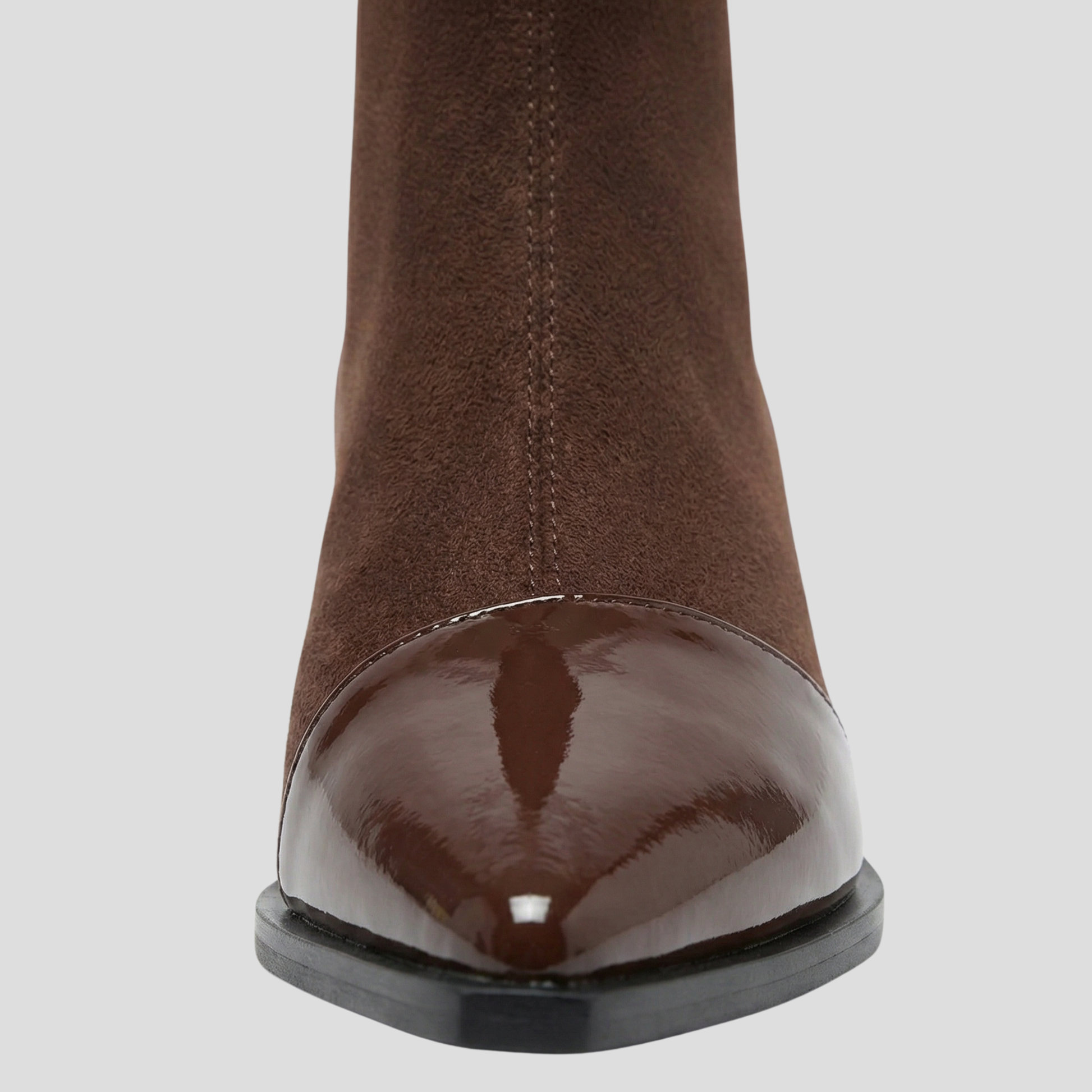 Women's ankle-height boots with contrast detail, shown in black and brown