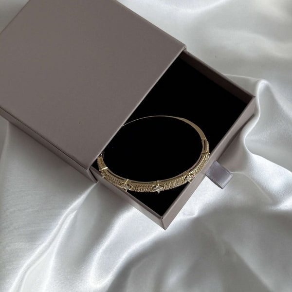 Hinged women's cuff bracelet with pavé panel detail in gold and silver tones